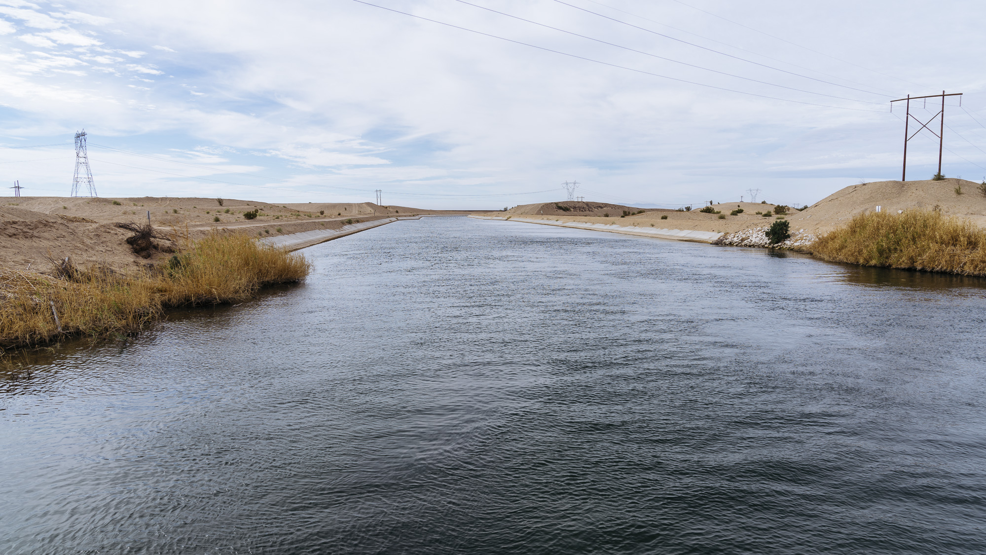  IMAGE CAPTION:  The All American Canal is America’s deadliest body of water. The largest irrigation canal in the world, it serves as an effective moat &nbsp;for migrants as it runs alongside the border wall in Calexico, California. 