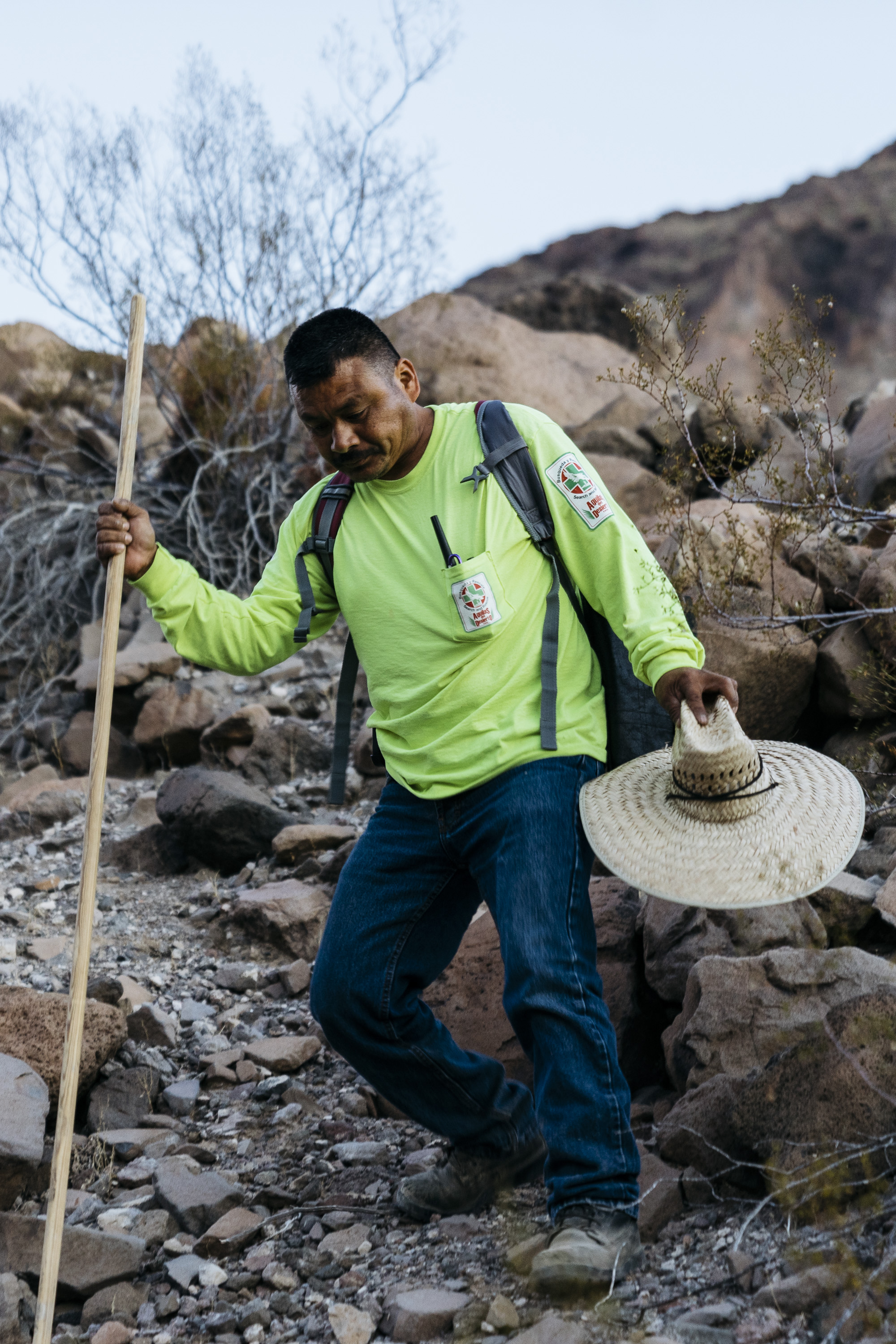  IMAGE CAPTION:  Maro Martinez, a volunteer with Aguilas Del Desierto, descends a wash in the Cabeza Prieta National Wildlife Refuge. Summer temperatures in this part of the Sonoran Desert can reach 120°F. 