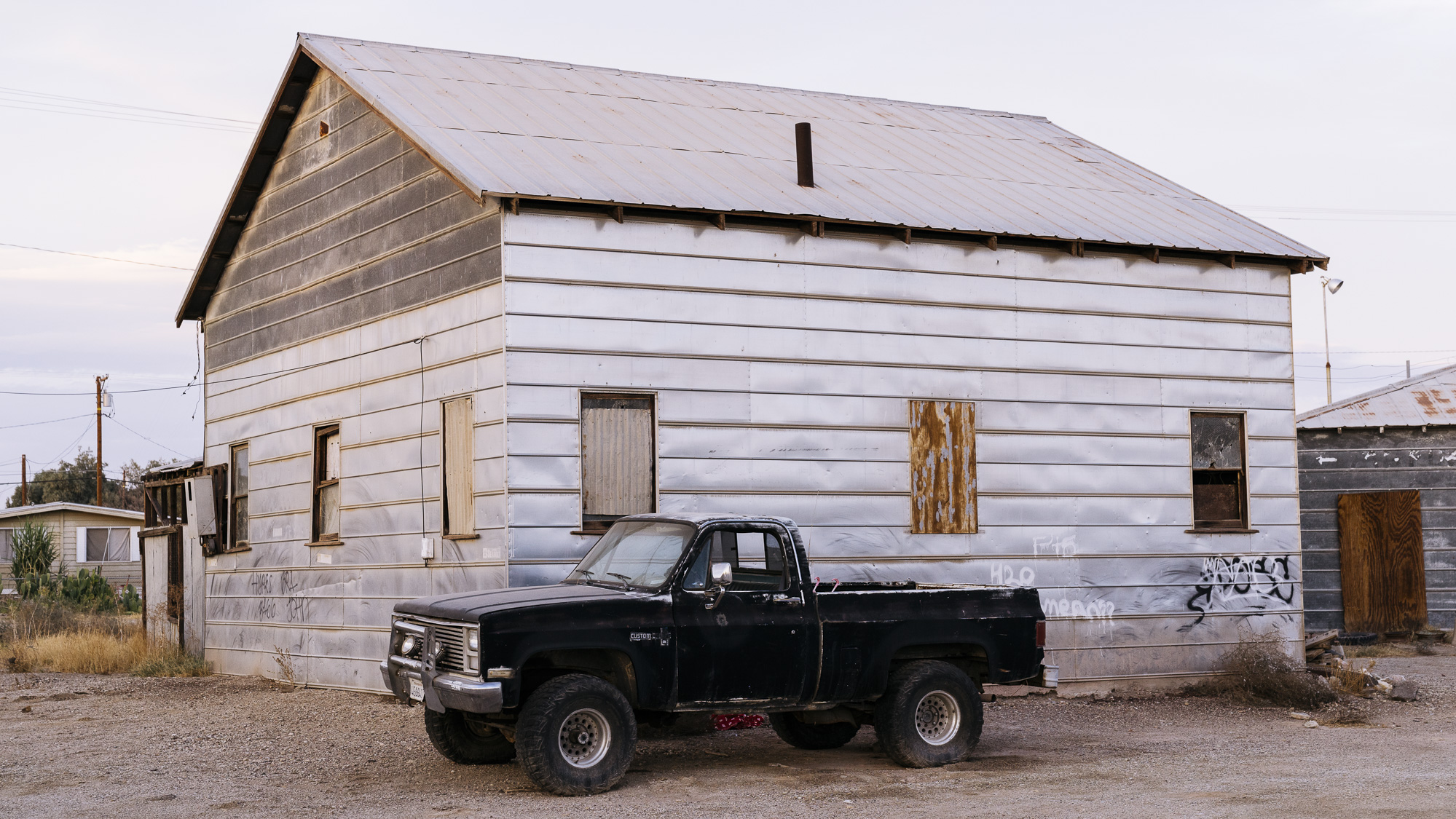  IMAGE CAPTION:  A truck parked outside an abandoned home in Niland, California. 40 miles from the Calexico Port of Entry. &nbsp; 