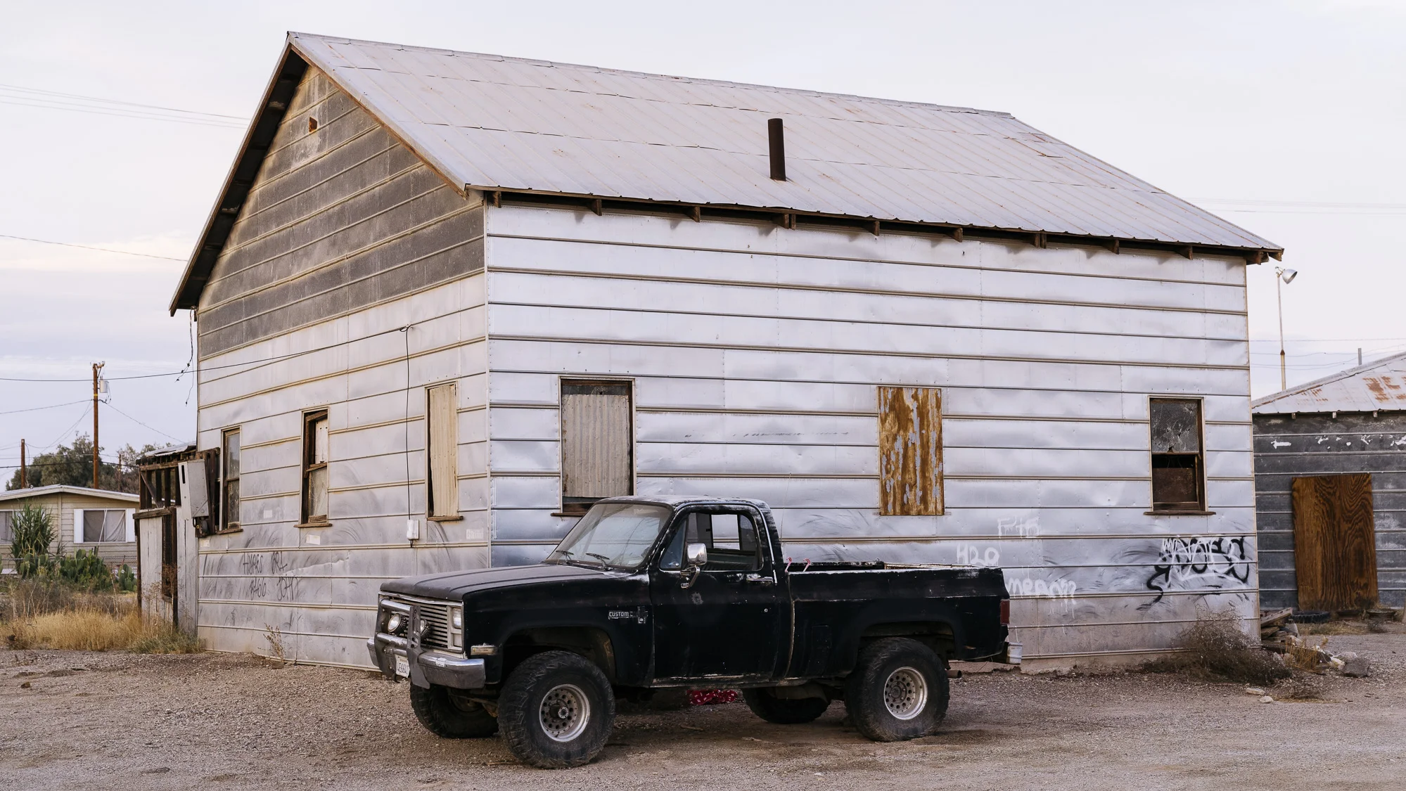IMAGE CAPTION: A truck parked outside an abandoned home in Niland, California. 40 miles from the Calexico Port of Entry. 
