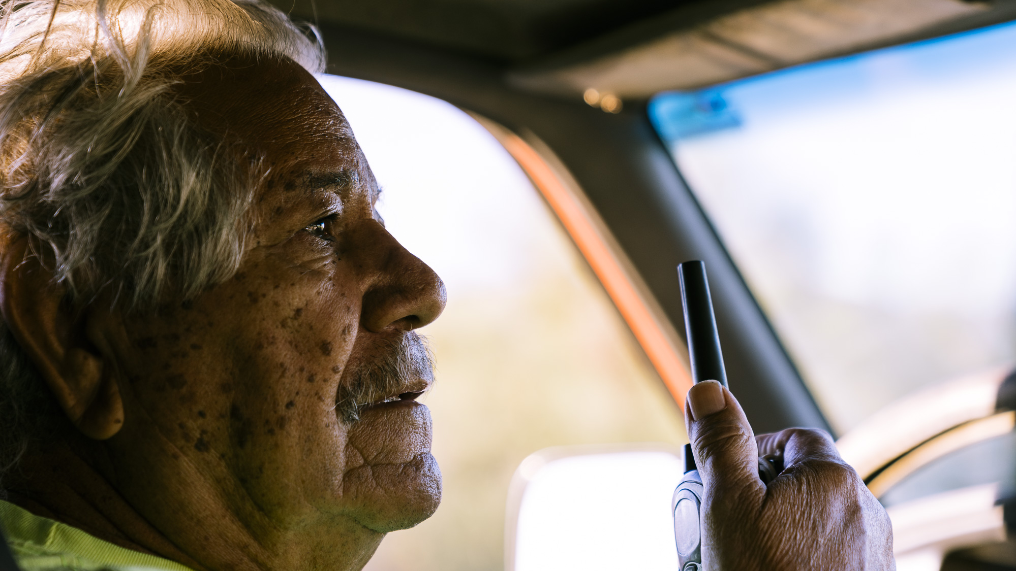  IMAGE CAPTION:  Vicente Rodriguez communicates with his team by radio while driving a 4x4 into the desert carrying supplies and volunteers for Aguilas Del Desierto. He has been involved in immigrant to migrants search and rescue efforts since 2009. 