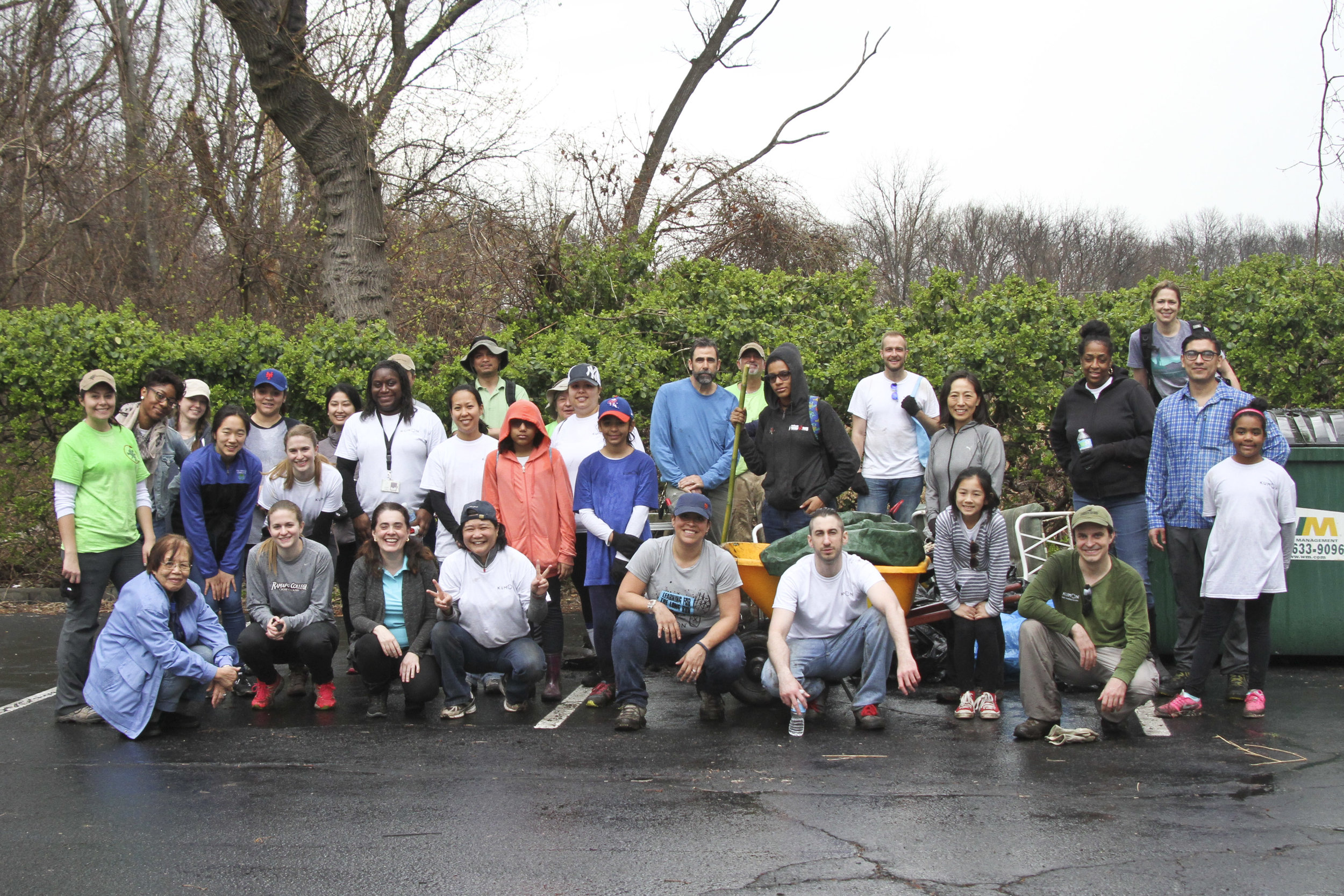  volunteer group photo on a rainy day. volunteers in ponchos. 