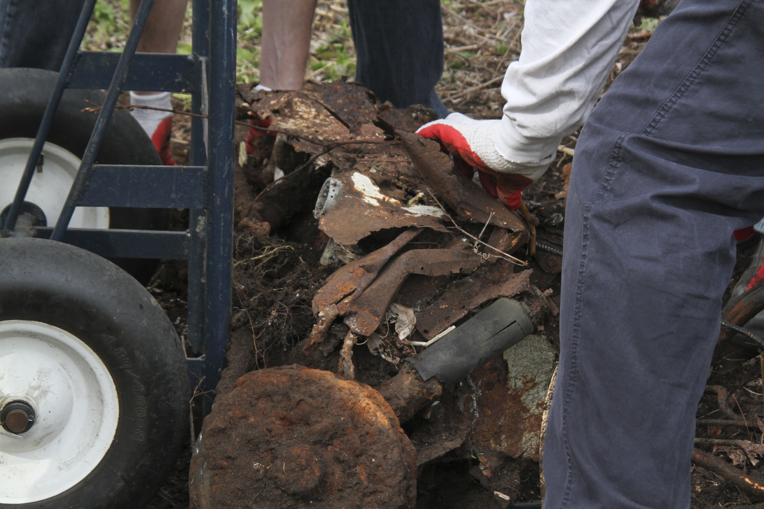  close up of metal debris being dug out of the soil 