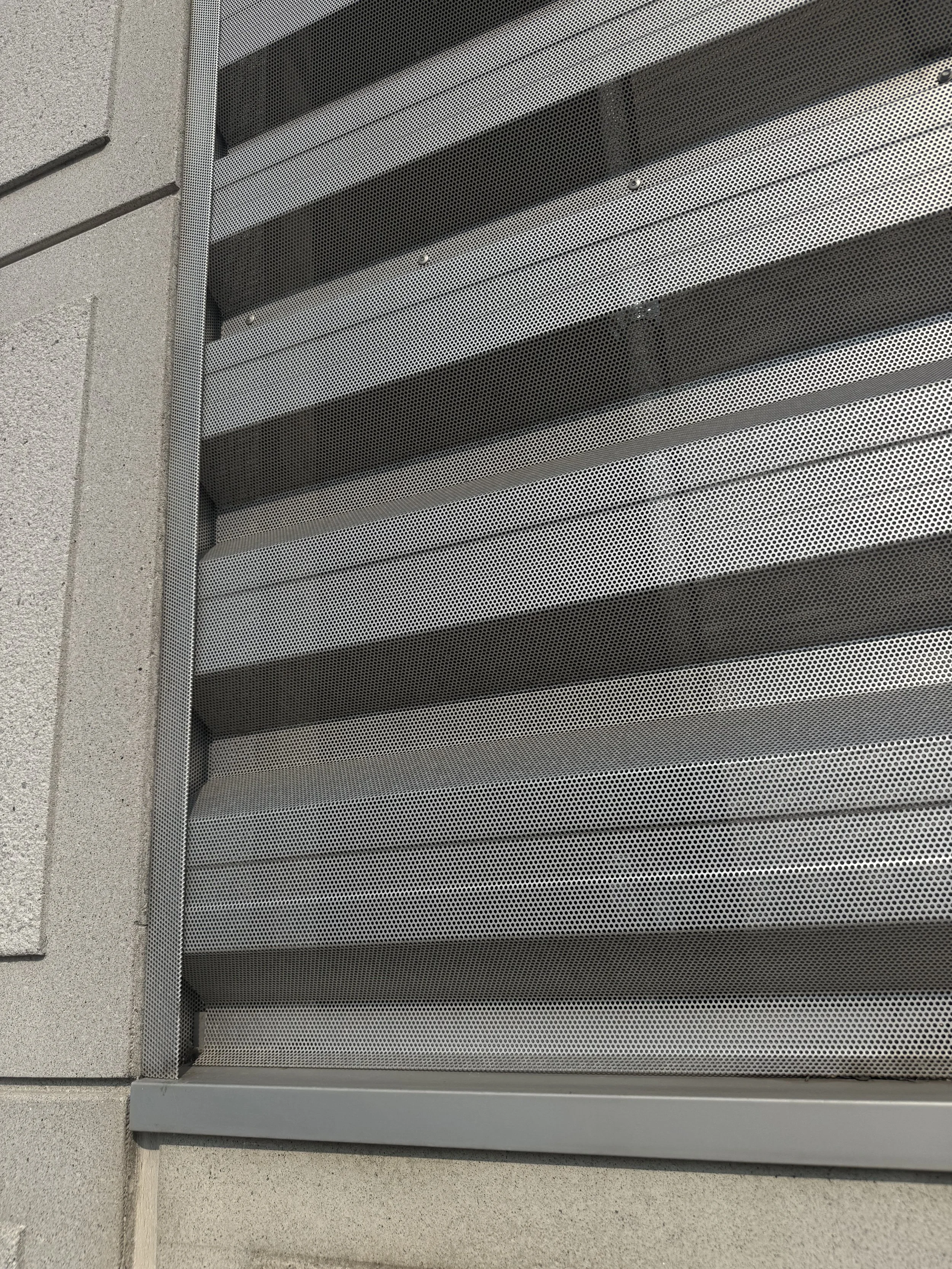 Exposed fastener perforated architectural single skin panels installed at the V.A. Medical Center Parking Ramp in Minneapolis, MN.