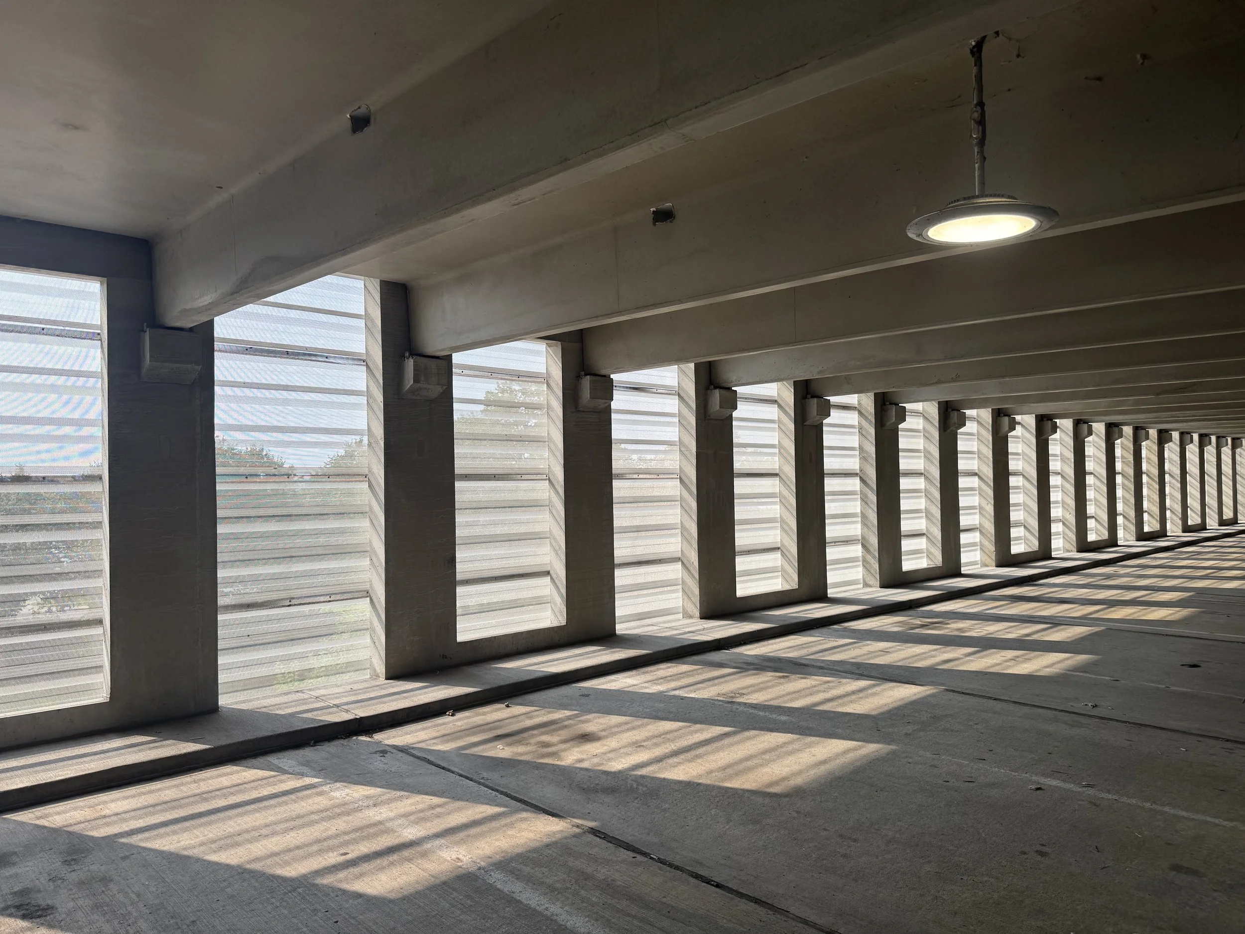 Exposed fastener perforated architectural single skin panels installed at the V.A. Medical Center Parking Ramp in Minneapolis, MN.