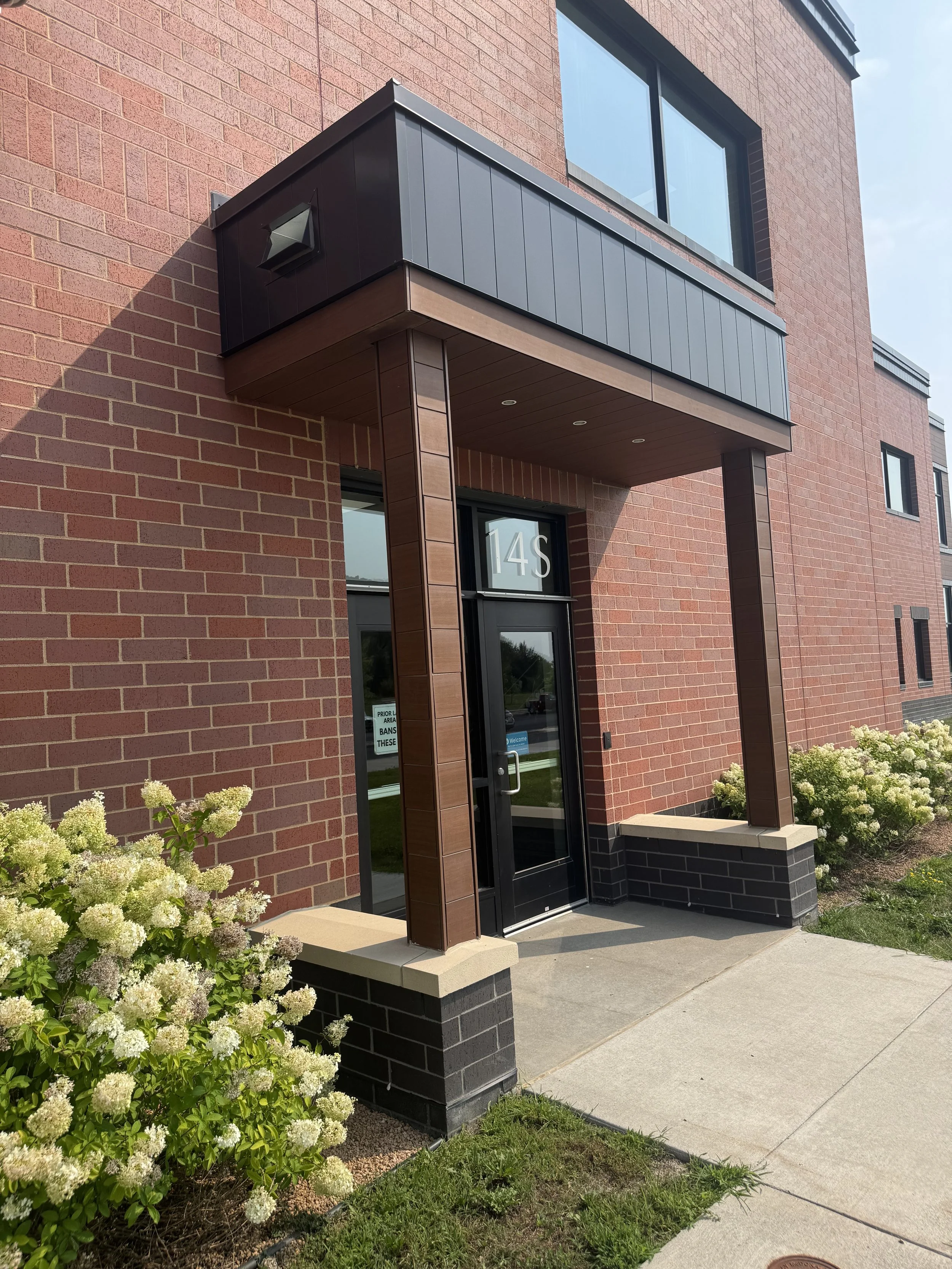Wood grain phenolic composite and architectural single skin panels installed at Hamilton Ridge Elementary School in Savage, MN.