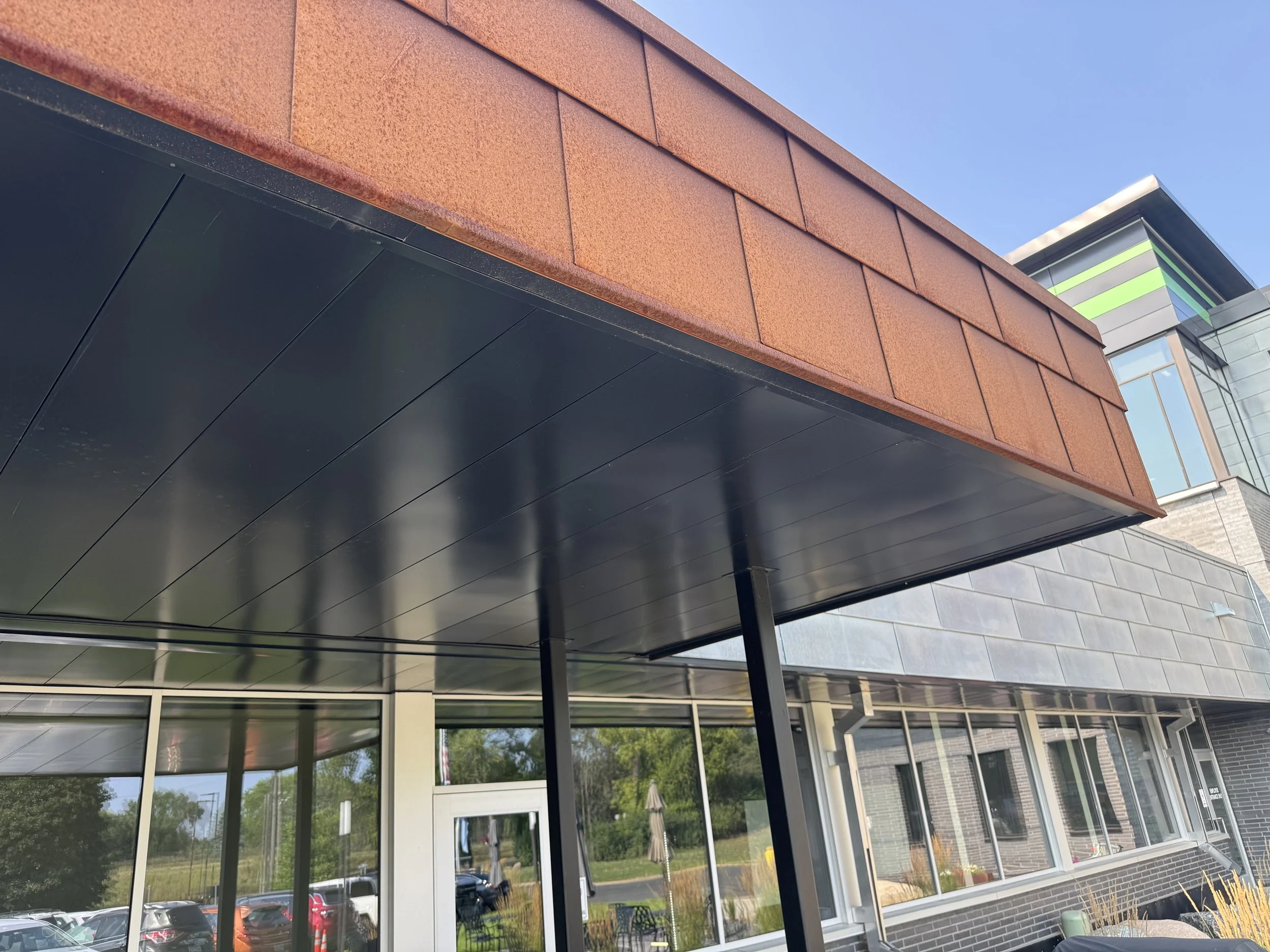 Zinc & Weathered Steel Flat Lock and architectural single skin panels installed at the SW Transit Leonard L Simich Maintenance & Administrative Facility in Eden Prairie, MN.