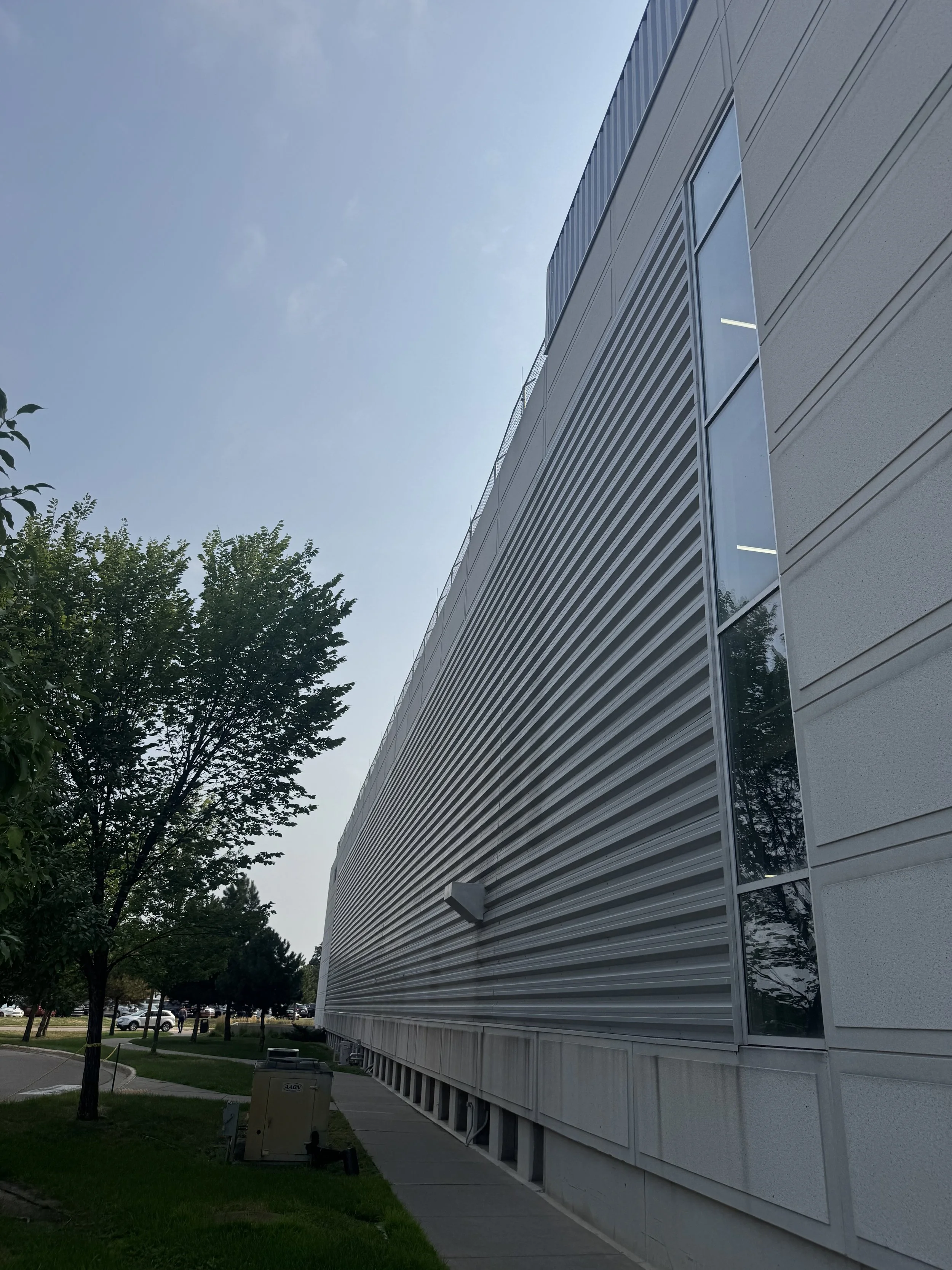 Exposed fastener perforated architectural single skin panels installed at the V.A. Medical Center Parking Ramp in Minneapolis, MN.