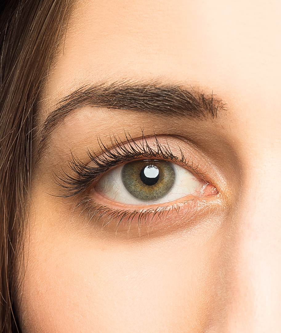 Close-up of a woman's face focusing on her classic lash extension set, well-groomed eyebrows, and smooth skin.