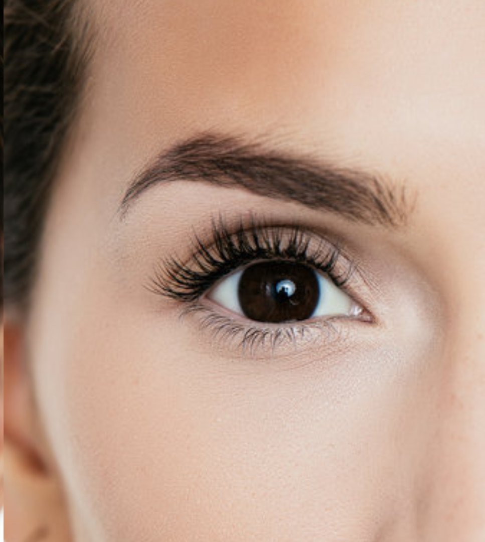 Comparison of a person's eyes showing natural eyelashes on the left and eyelash extensions on the right.