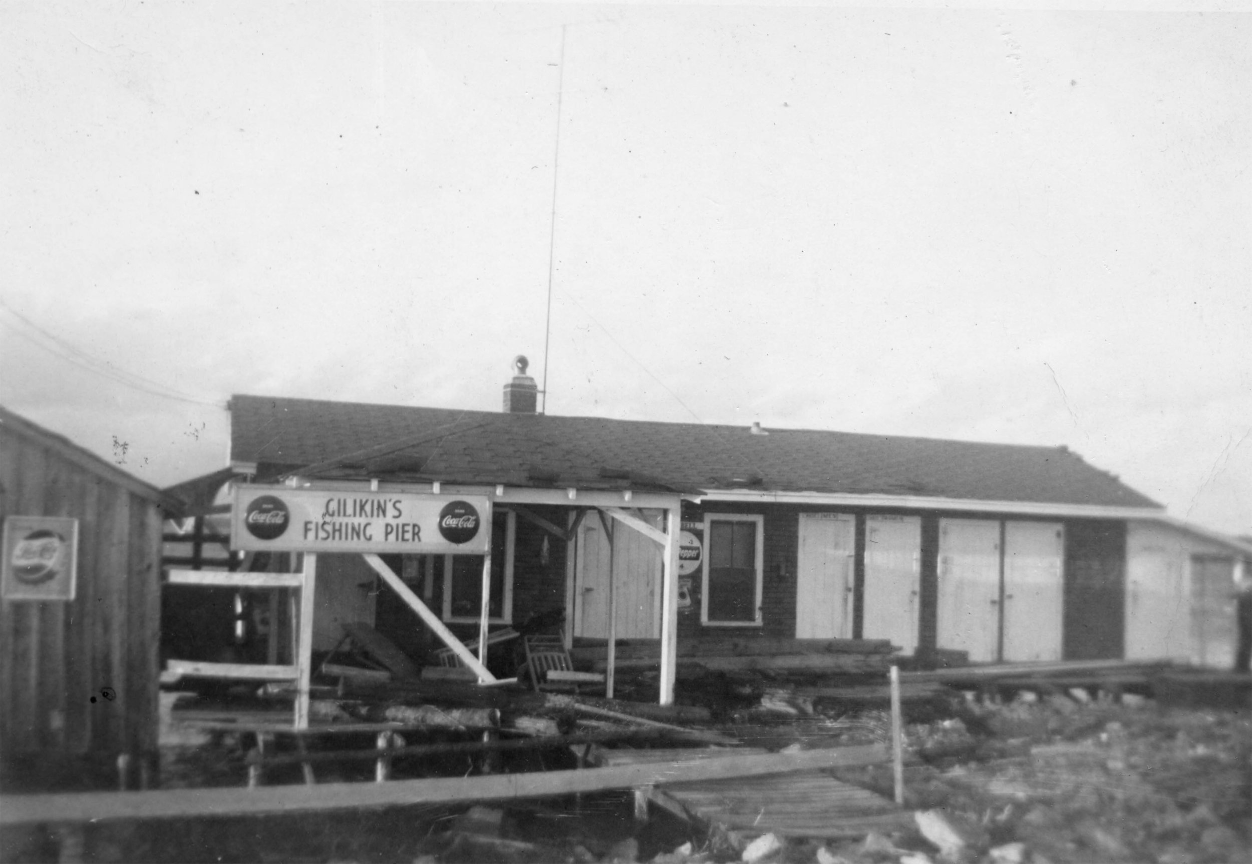 H. Gillikin's fishing pier after a hurricane, probably Hazel. Formerly located on the Bettie side of the North River bridge.