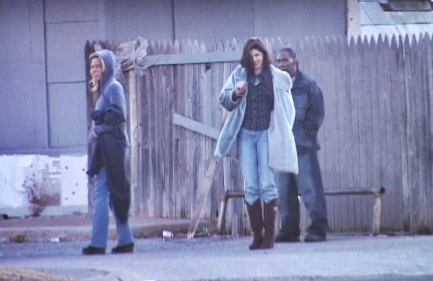 A pimp & his two prostitutes.