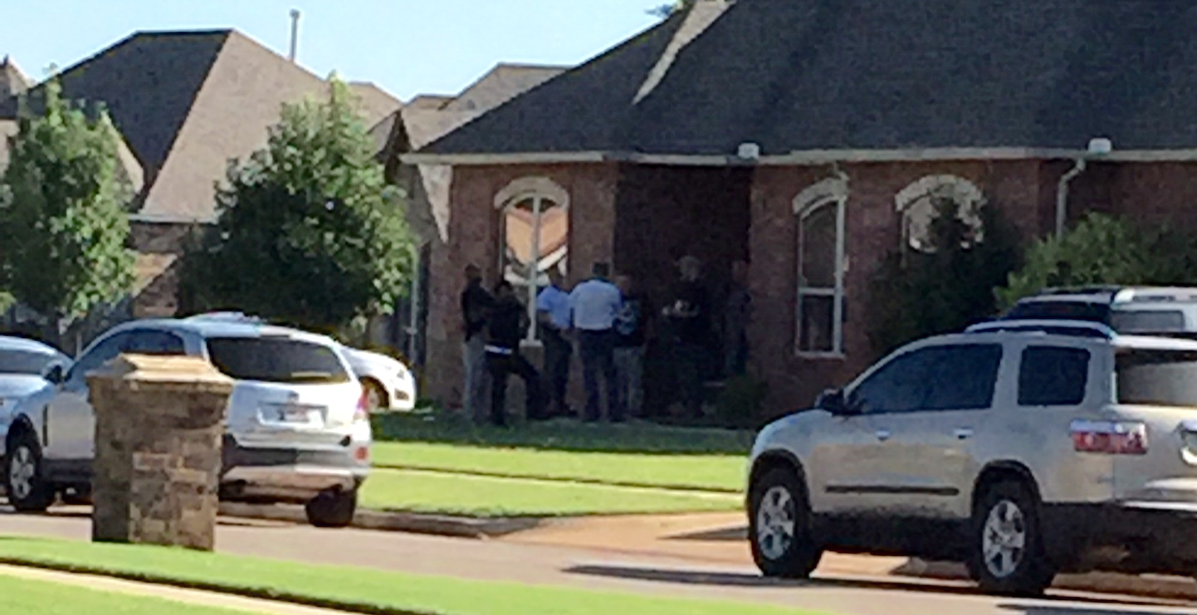 Federal law enforcement officers serve a search warrant of the Gum residence.