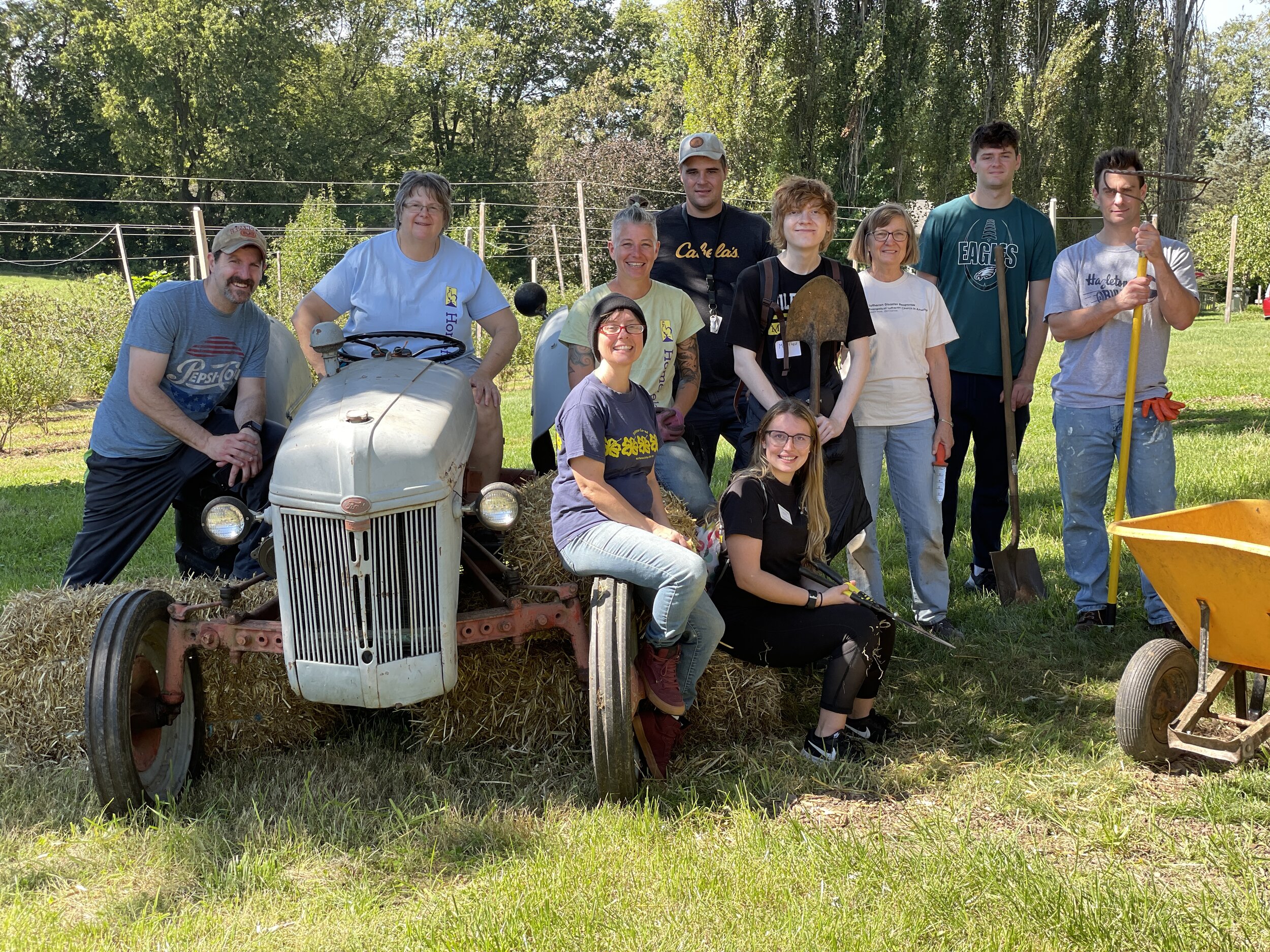  Volunteers from Millersville University Honors College and friends of Homefields surround Allison Hawthorne (riding the tractor). Allison spearheads the event and this crew put the final touches onto the property the day before. 