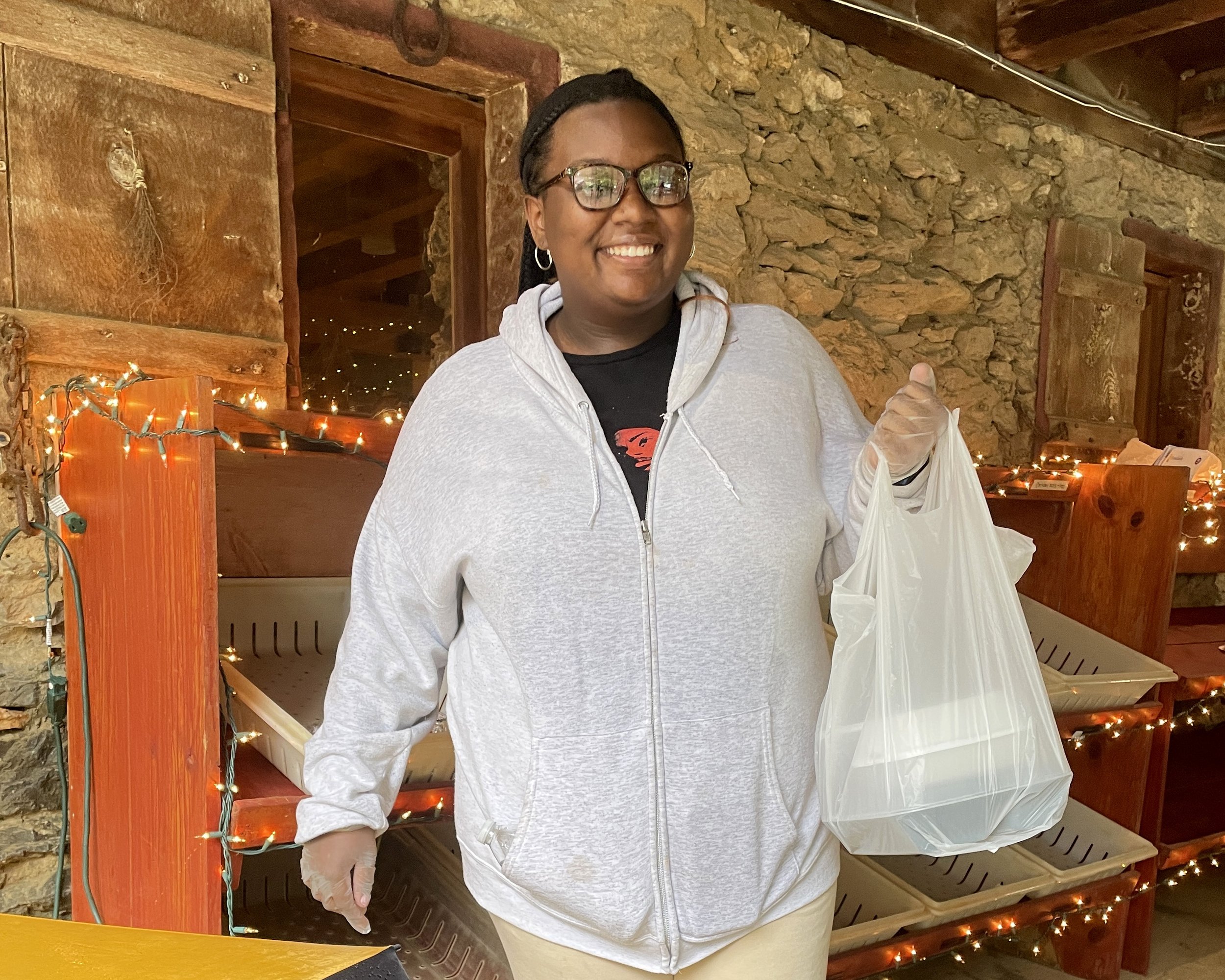  This student from Millersville University transported meals from the prep area to vehicles as they circled the barn. 