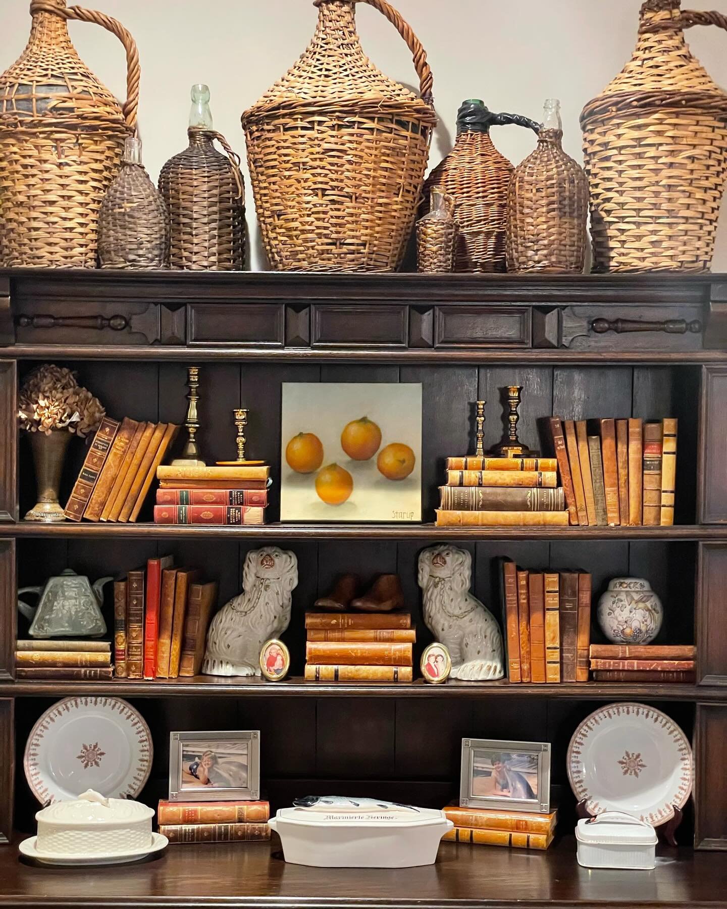 Shelf Accessorizing Tips:
1. Start with the largest pieces first. This can be artwork, plates on stands, or large sculptural pieces. 
2. Fill large holes with stacks of books both standing up and laying down.
3. Sprinkle in the small accessories last