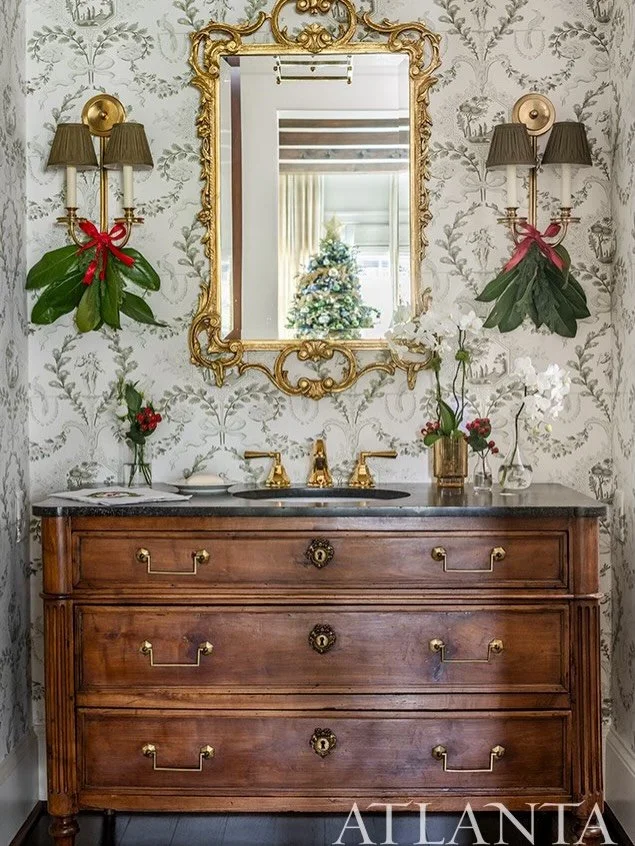 Swipe for the transformation ➡️
From dark + dated to charming + collected.
We reimagined this powder bath with elegant wallpaper, a vintage-inspired mirror, fresh lighting, and layered holiday details.
Small space, major upgrade. 🤍

📸: @jeffherrpho