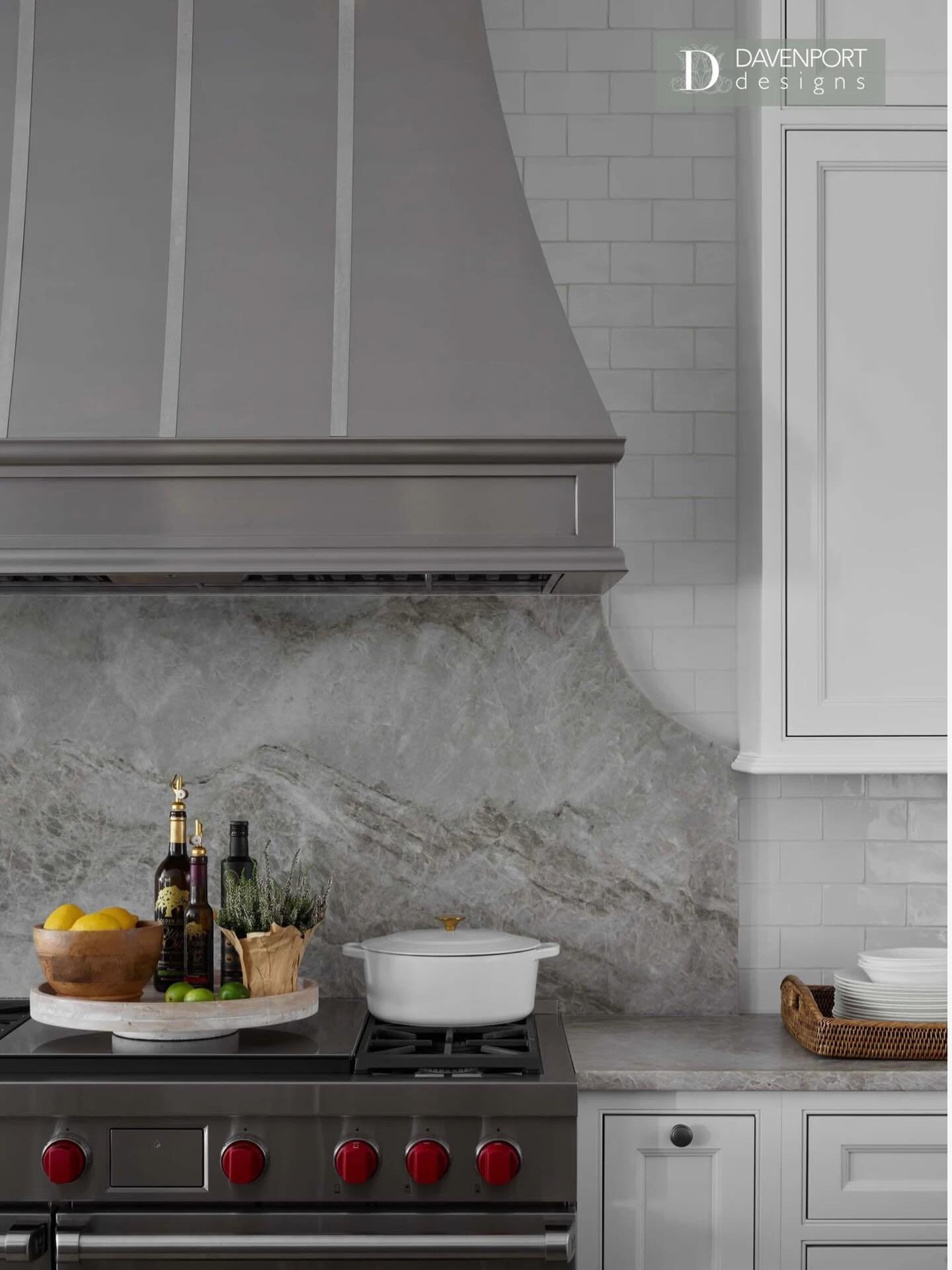 Soft neutrals, layered texture, and a little something simmering 🍋🤍

This range wall is all about quiet contrast &mdash; a tailored custom range hood, a sweeping slab backsplash with natural movement, and crisp cabinetry that keeps it feeling fresh