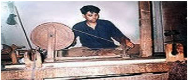 spinning  the yarn on a hand loom.jpg