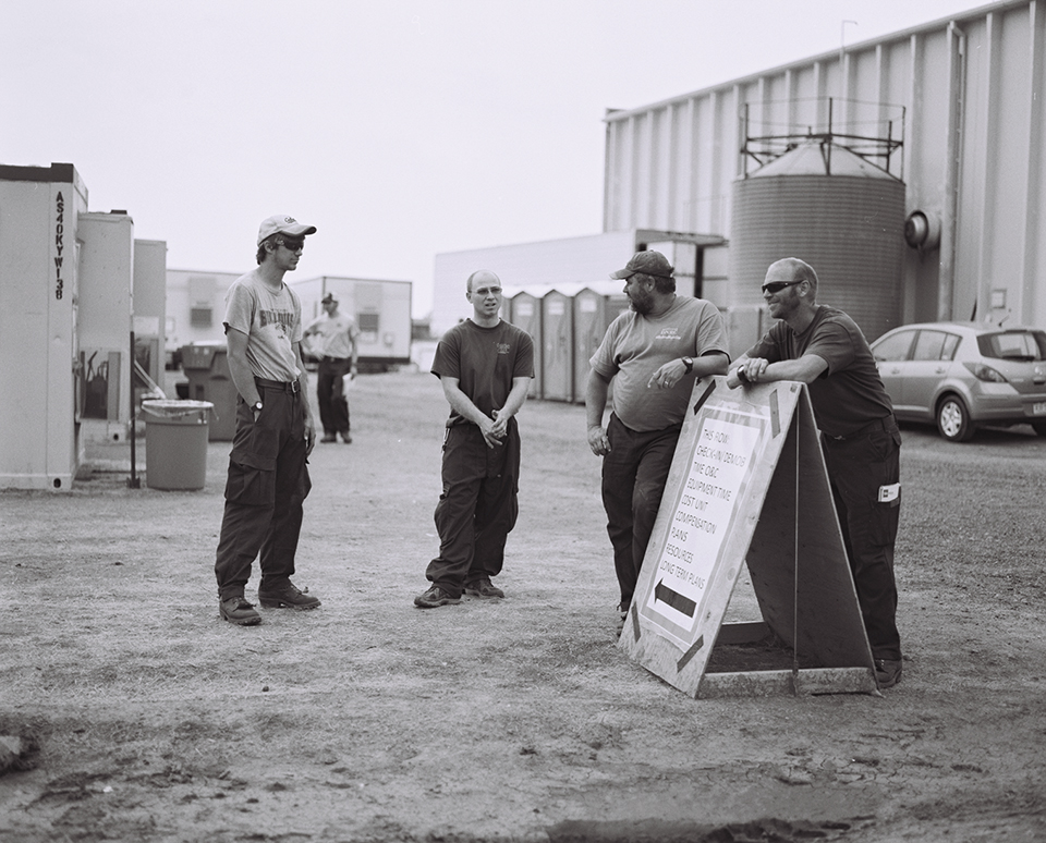 Crew members near the command trailers. Each trailer represents a different area of logistics management for the fire camp.