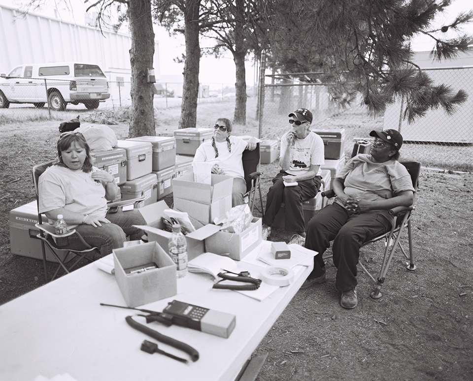 Communication crew members at the battery station. The batteries for all walkie talkie and portable devices are changed every day to ensure reliability. Crates hold each crew’s replenished devices, ready for the next day’s use.