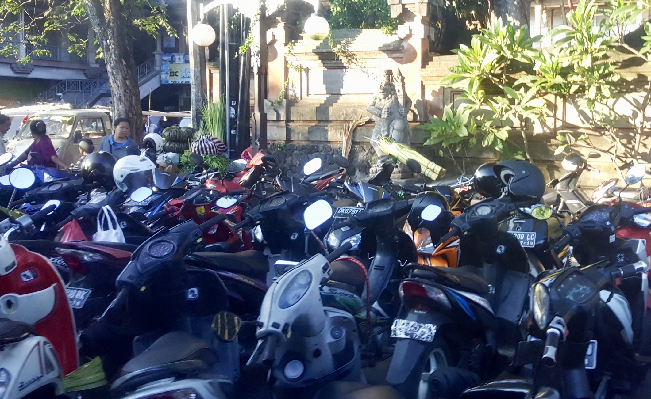Scooters on the sidewalk, next to the crazy traffic of Ubud, Bali, Indonesia