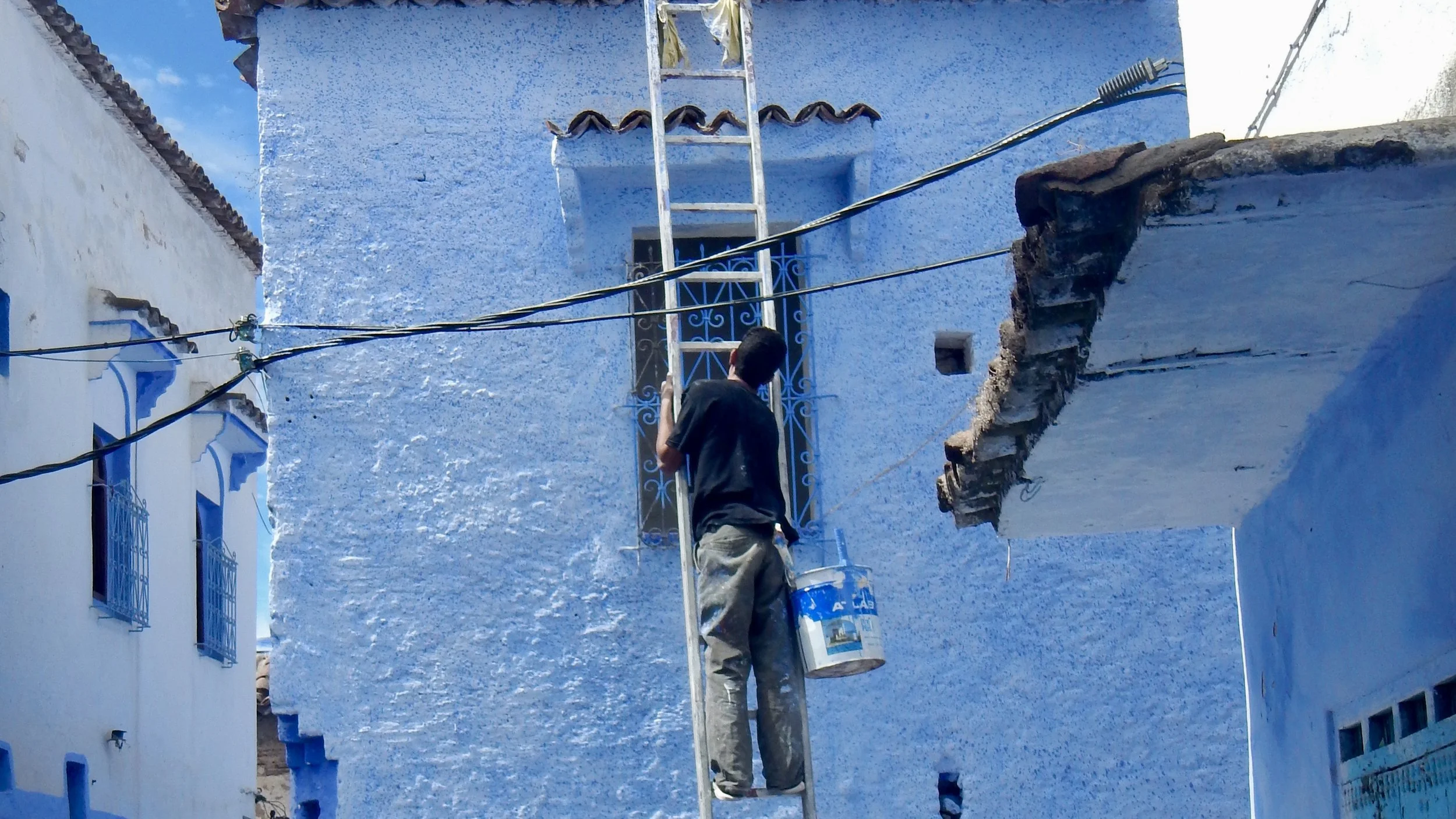 Man painting the walls blue! Chefchaouen, Morocccoui