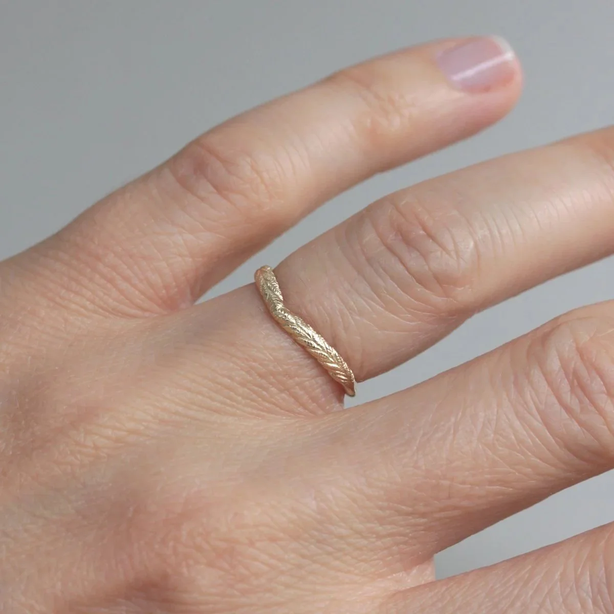 orange_blossom_wishbone_wedding_ring_on_hand_2.jpg