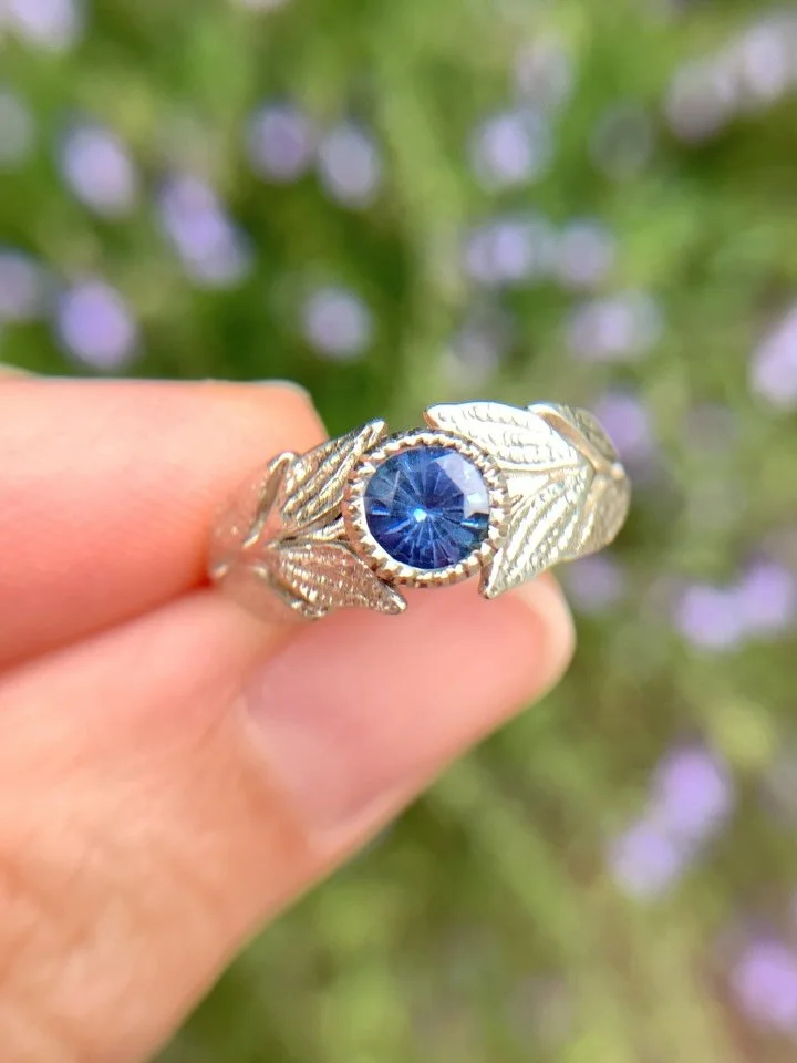It&rsquo;s a a grey day here but this white gold leafy treasure and its Sri Lankan blue sapphire is glimmering among the salvias. 🩵✨ I&rsquo;m holding on to glimmers at the moment - little moments of joy, signs of hope and kindness from others. 
.
T