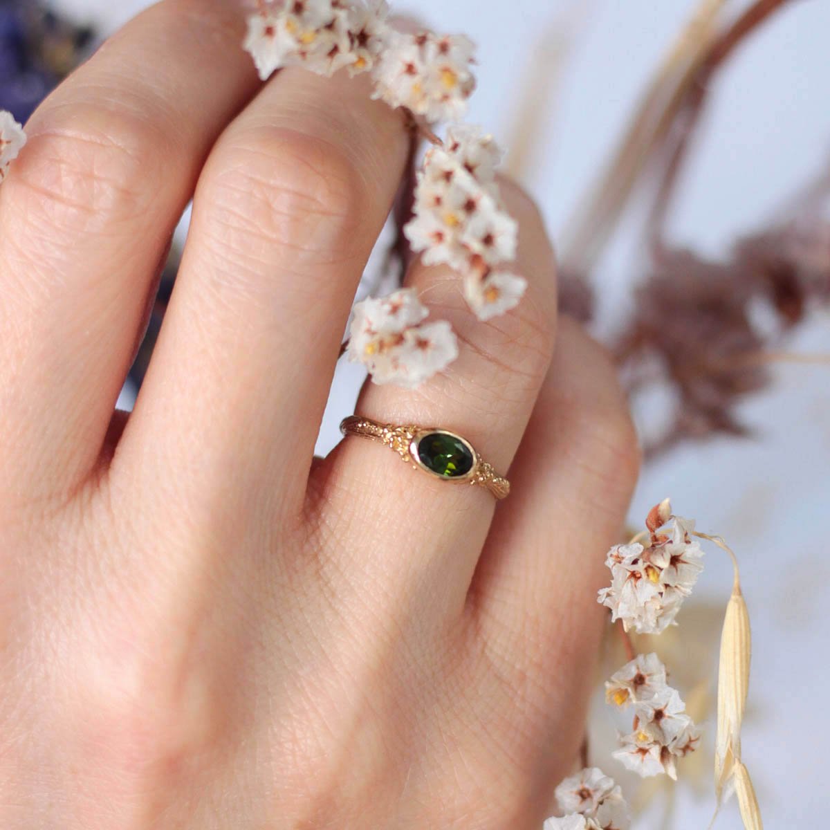 oval_green_tourmaline_ring_on_finger.jpg
