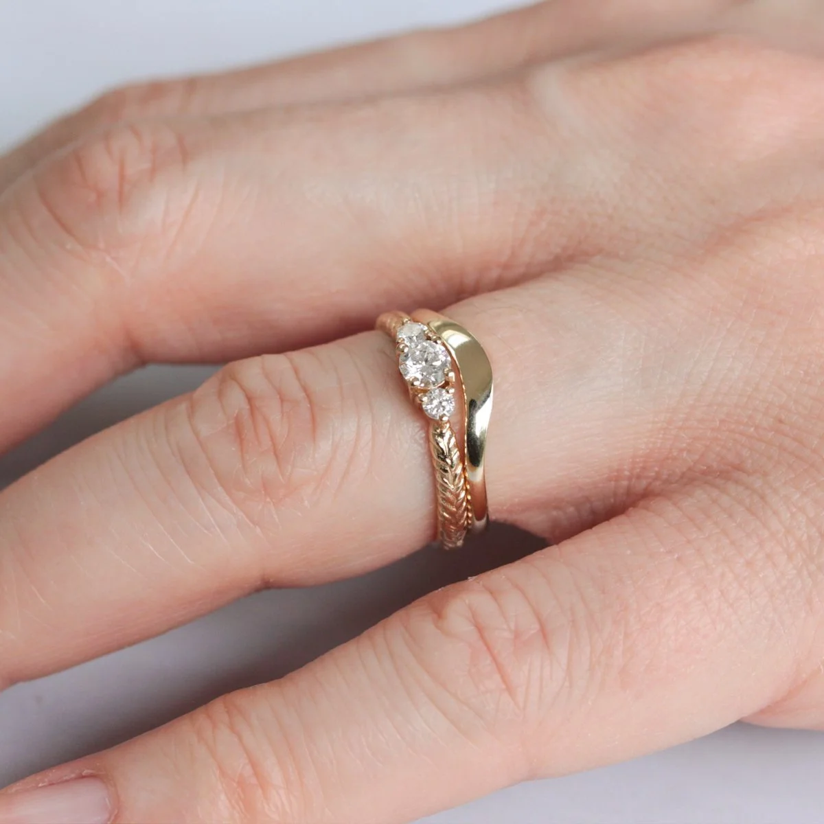 gold_nature_wedding_rings_on_hand.jpg