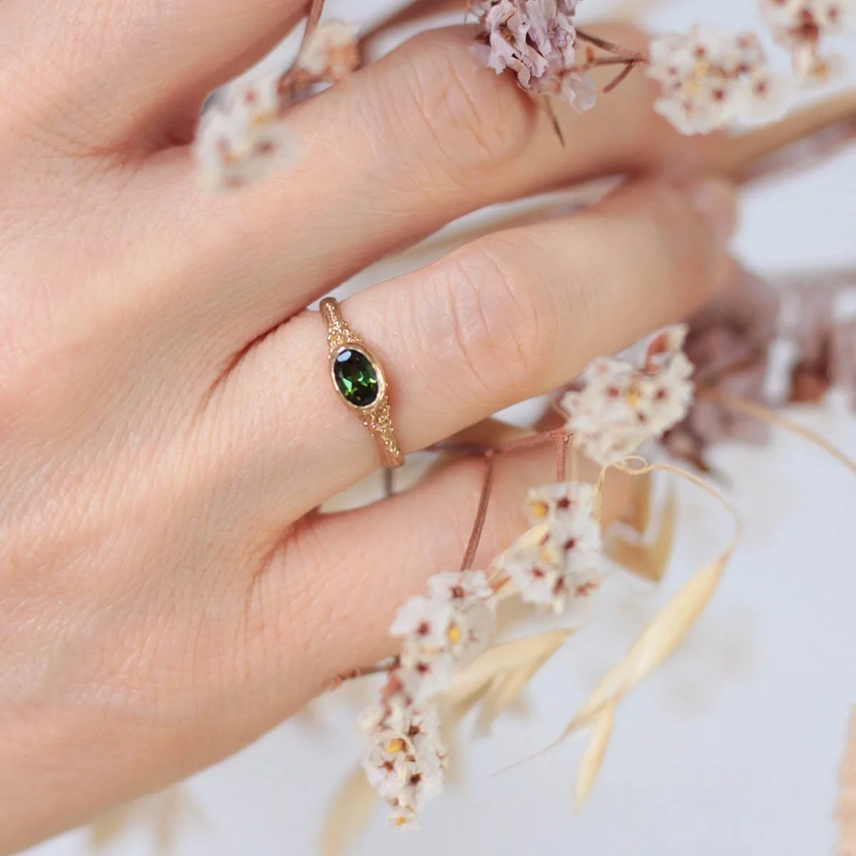 green_tourmaline_ring_on_hand.jpg