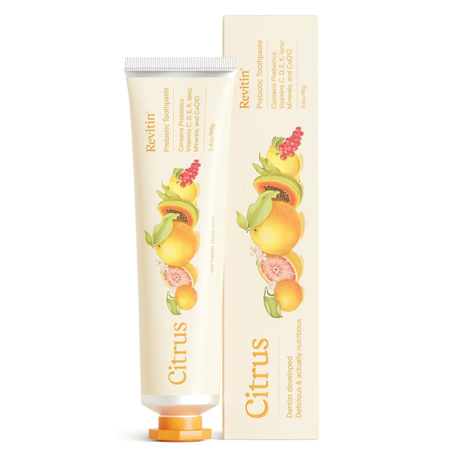 A tube of Revitin citrus flavored toothpaste next to its box, featuring illustrations of various citrus fruits like oranges, grapefruit, and lemon, with text highlighting health benefits and ingredients.