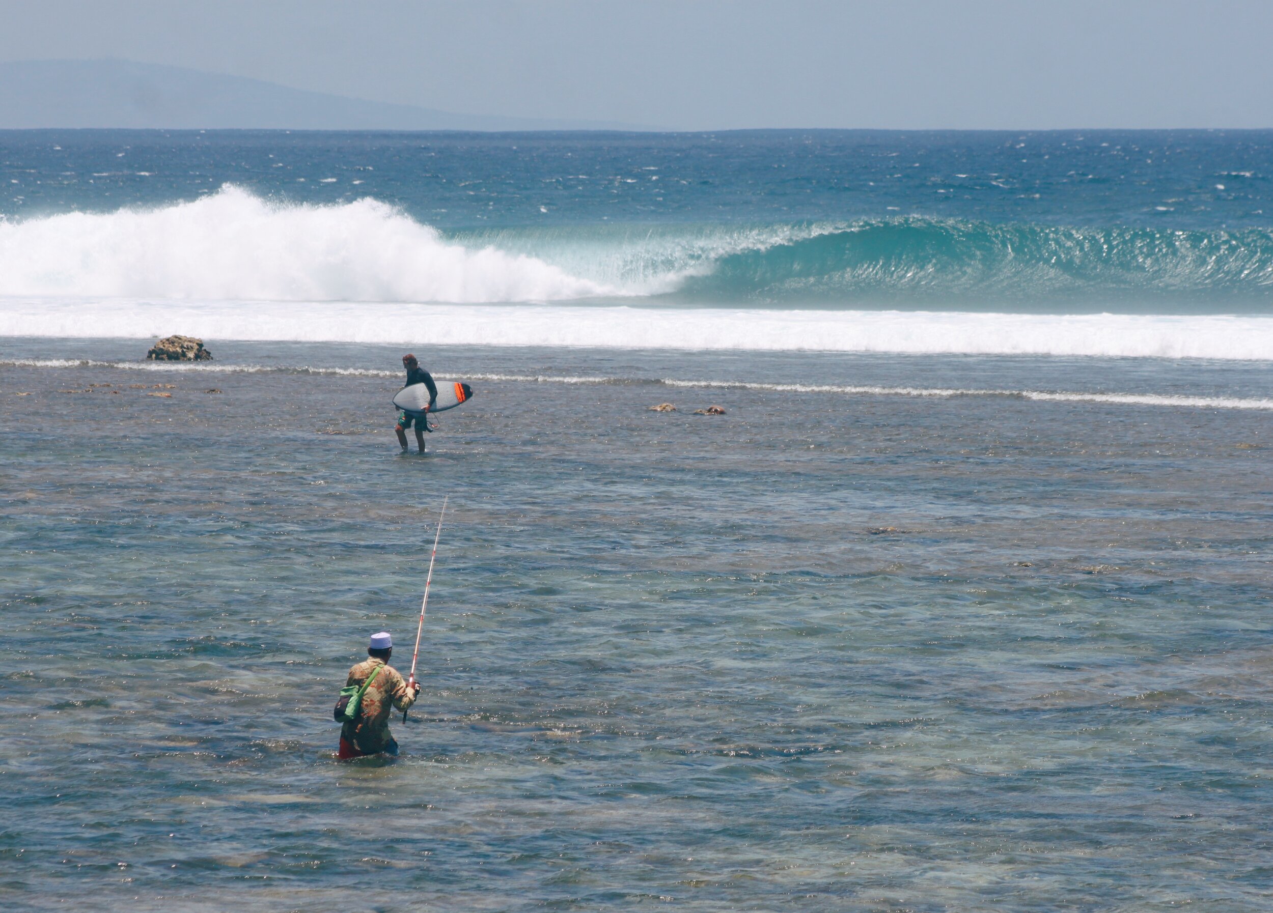  Brian making the walk over the sharp, shallow reef. Desert Point, Lombok. 
