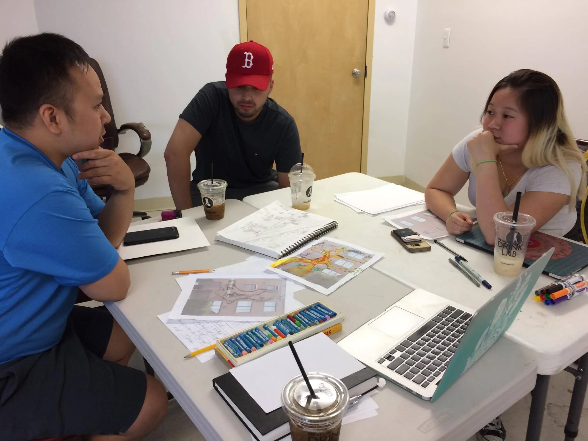 Left to right: Tam, Tony, and Kathy (Photo: Tran) Artist's at work! In the moment, artist team were discussing how designs could improve!