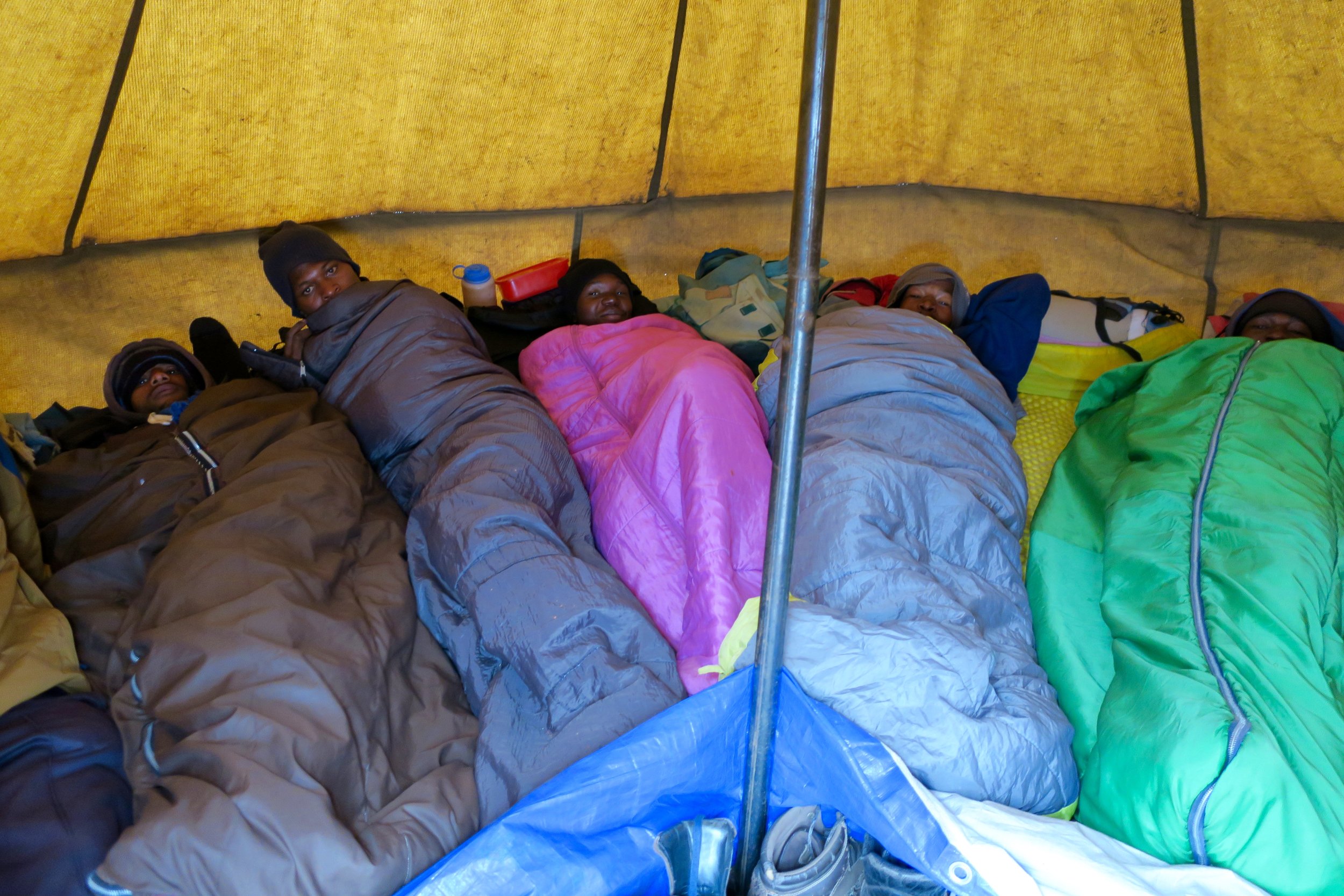 Once camp is set up, the porters waste no time before getting into their shared tents.