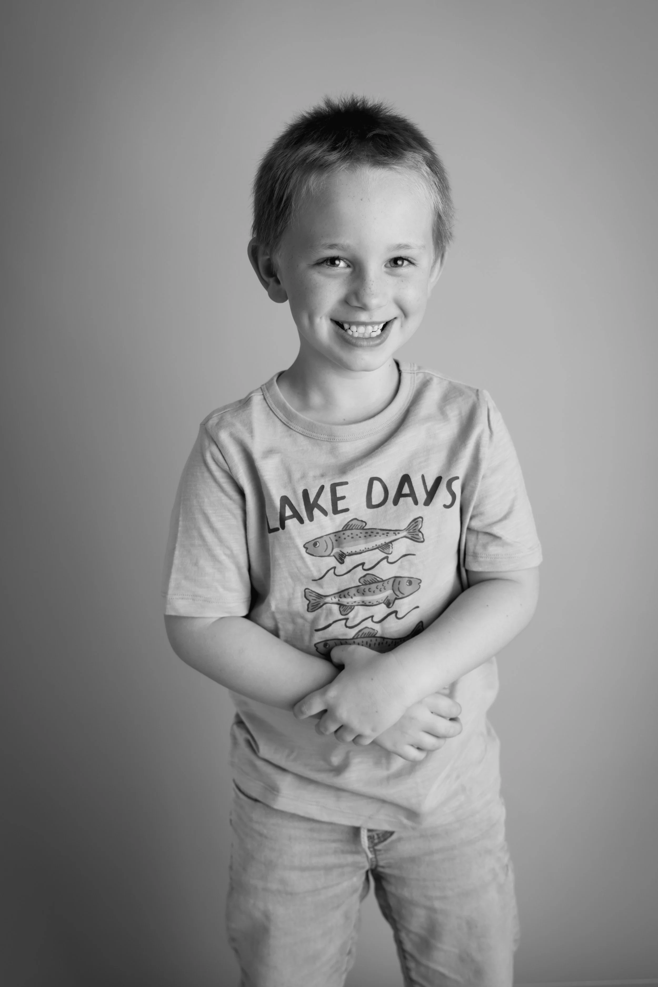 Young boy smiling in black and white