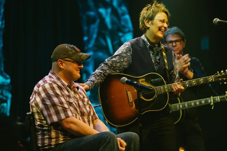 Mary Gauthier with Veteran and Co-Writer Josh Geartz on stage in Franklin, TN Photo by Kyle Dean Reinford for The New York Times