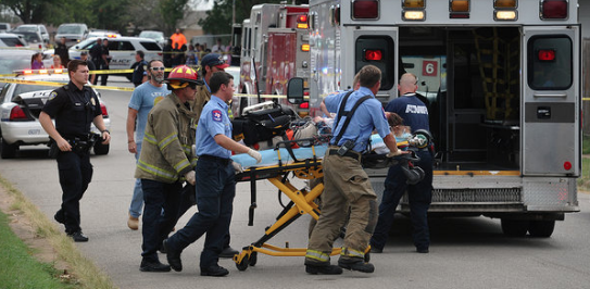 Paramedics scramble on Friday, September 2, 2016 after a gunman shot two school girls in Wichita Falls. Police are searching for a white male about age 18 in the attack.