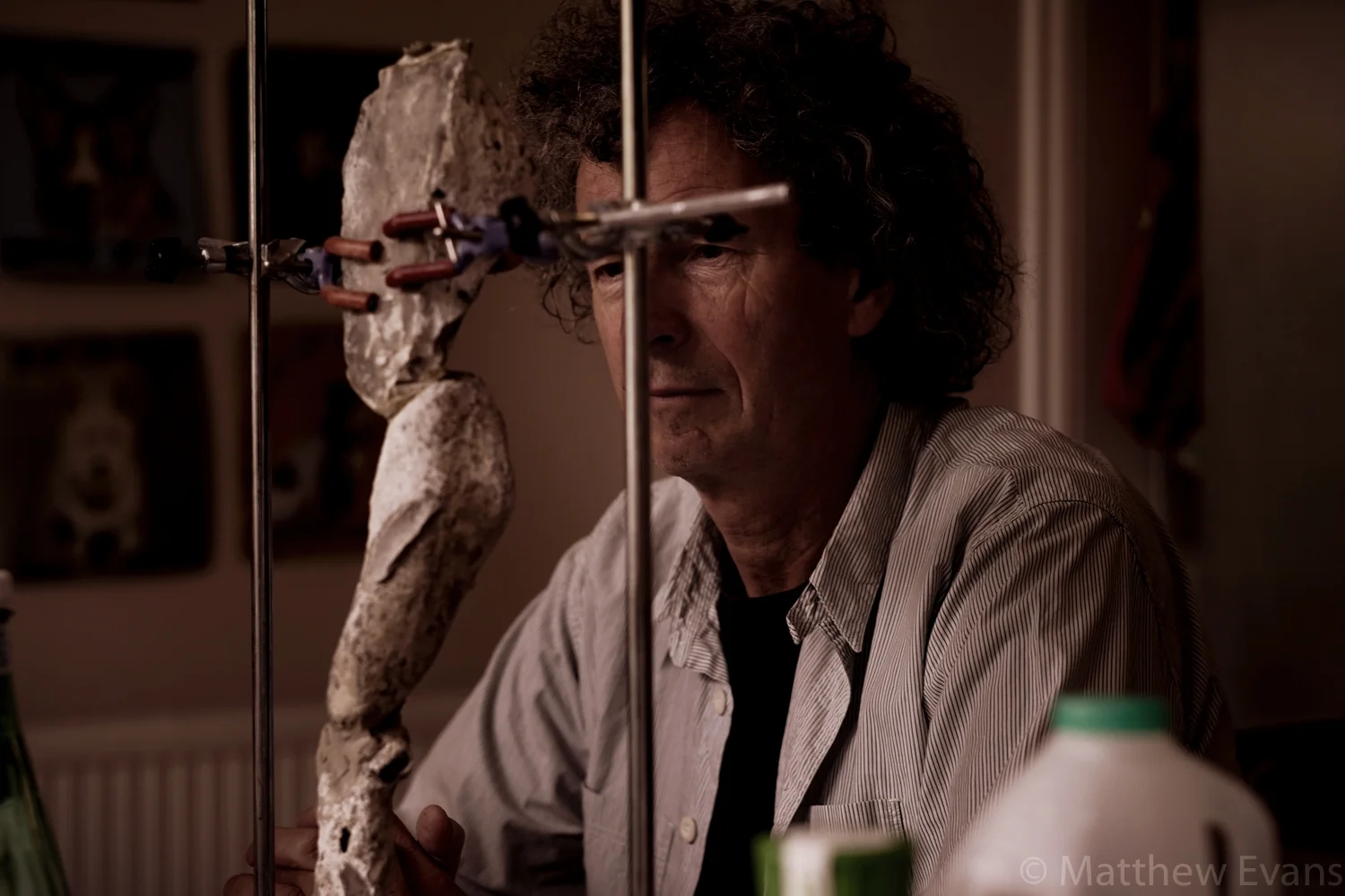Orlando Gough, mending a sculpture 
