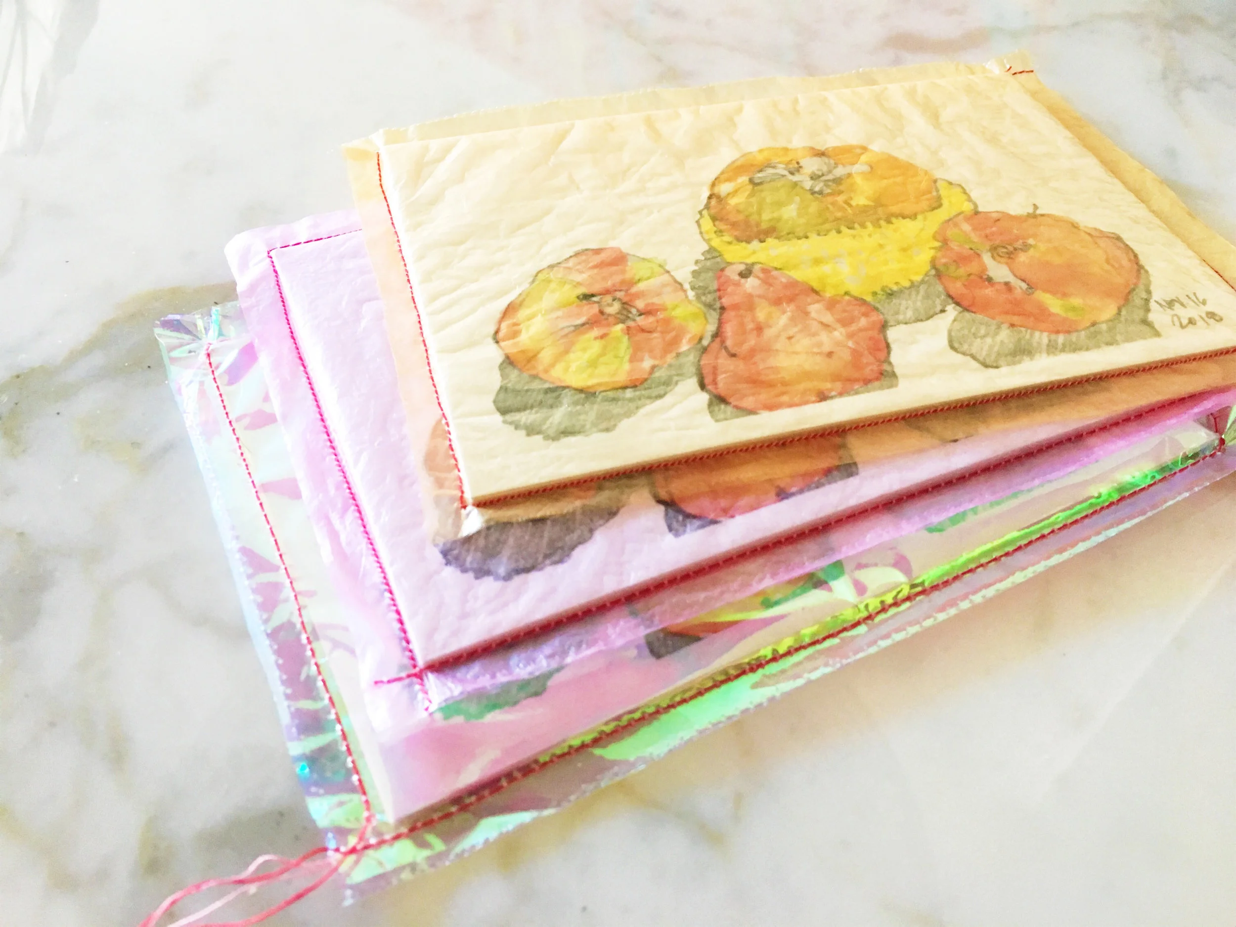 Chinese bakery plastic bags repurposed into packaging, stitched with silk-cotton thread.