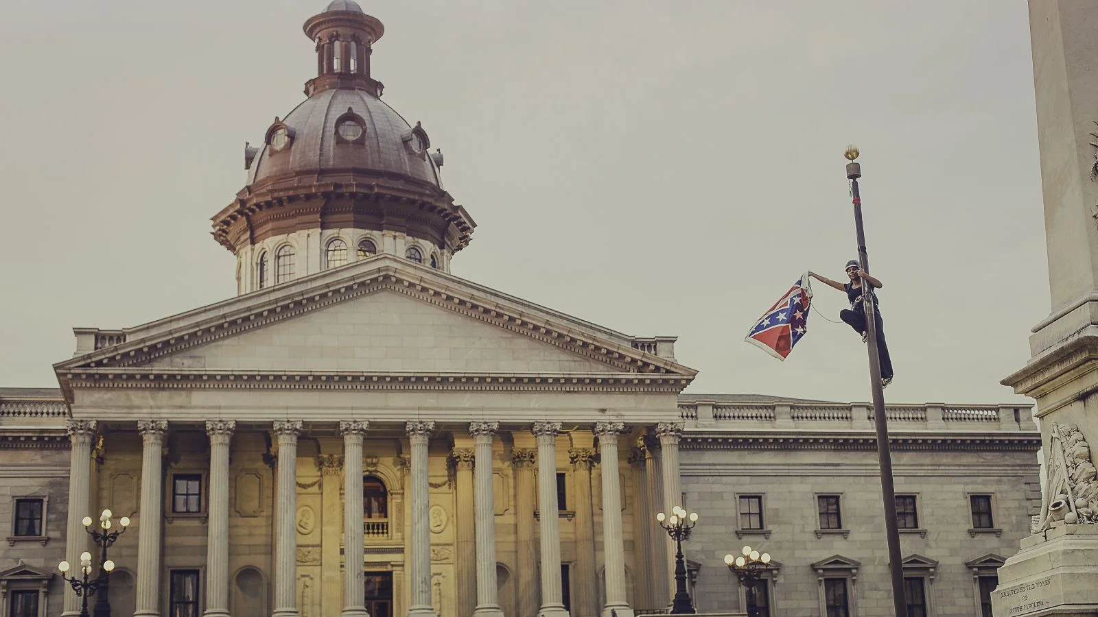 Bree Newsome removes the confederate flag outside the South Carolina Statehouse, 2015; photo: Adam Anderson