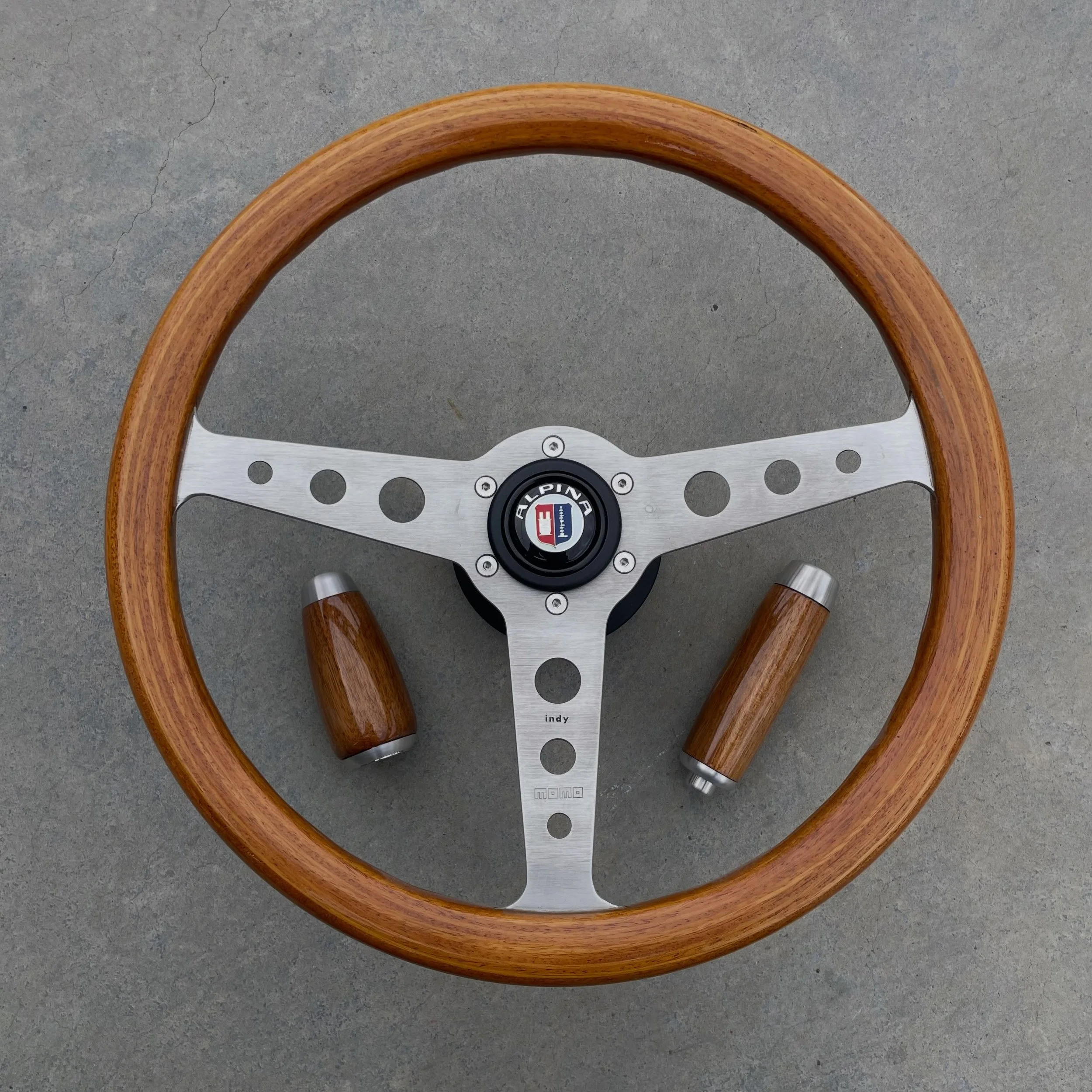 YARD SALE! 
Date stamped 12-&lsquo;79 this vintage 375mm MOMO steering wheel is in amazing original condition, with bright wood rim and anodized aluminum spokes. finished off with a genuine MOMO/ALPINA horn button and solid aluminum 2002/1600 adapter