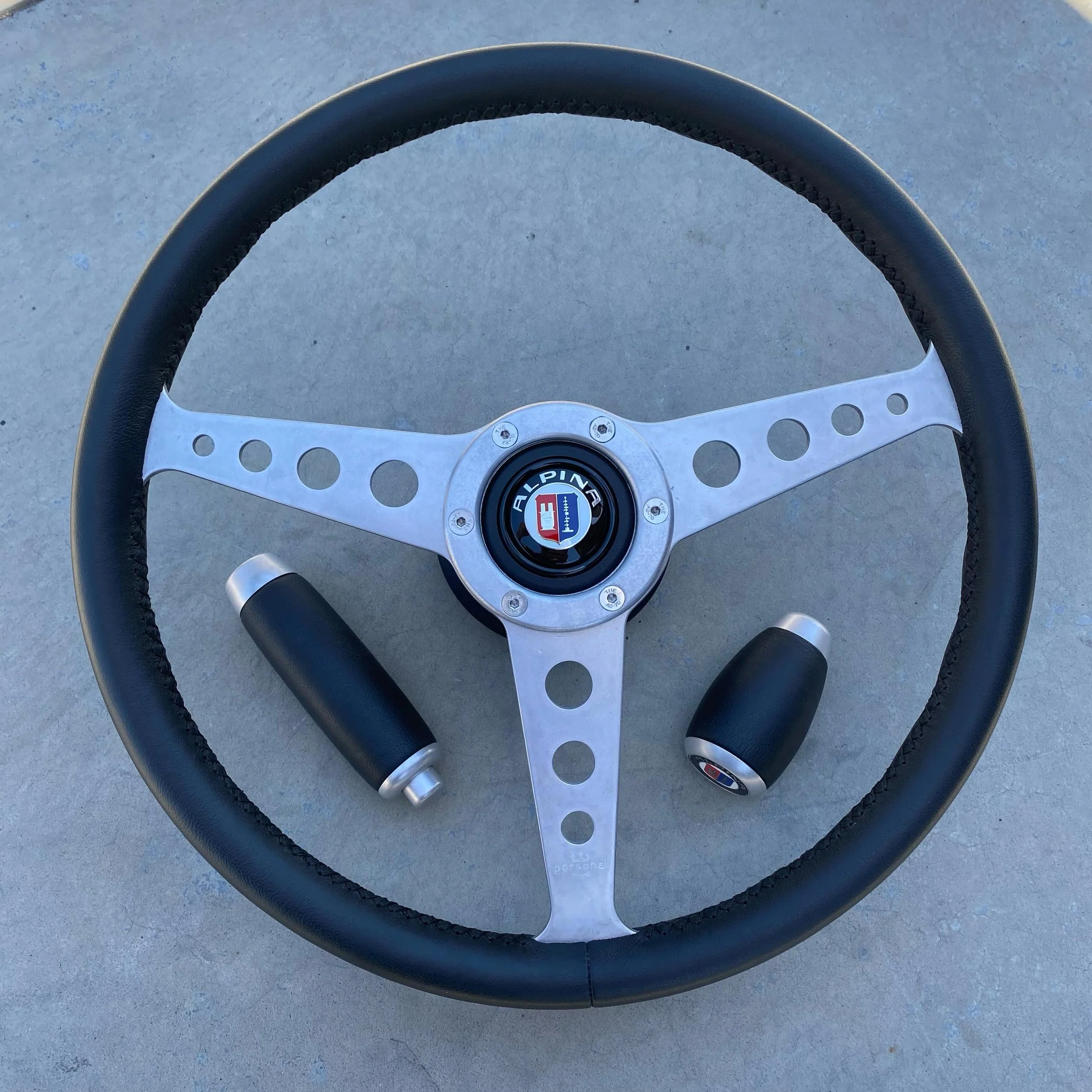 The ultimate 2002 control package.

Date stamped 3-&rsquo;70, this original 365mm Personal steering wheel has been meticulously restored with tumbled aluminum finished spokes, Wrapped in high quality Leather and hand stitched by our master craftsman.