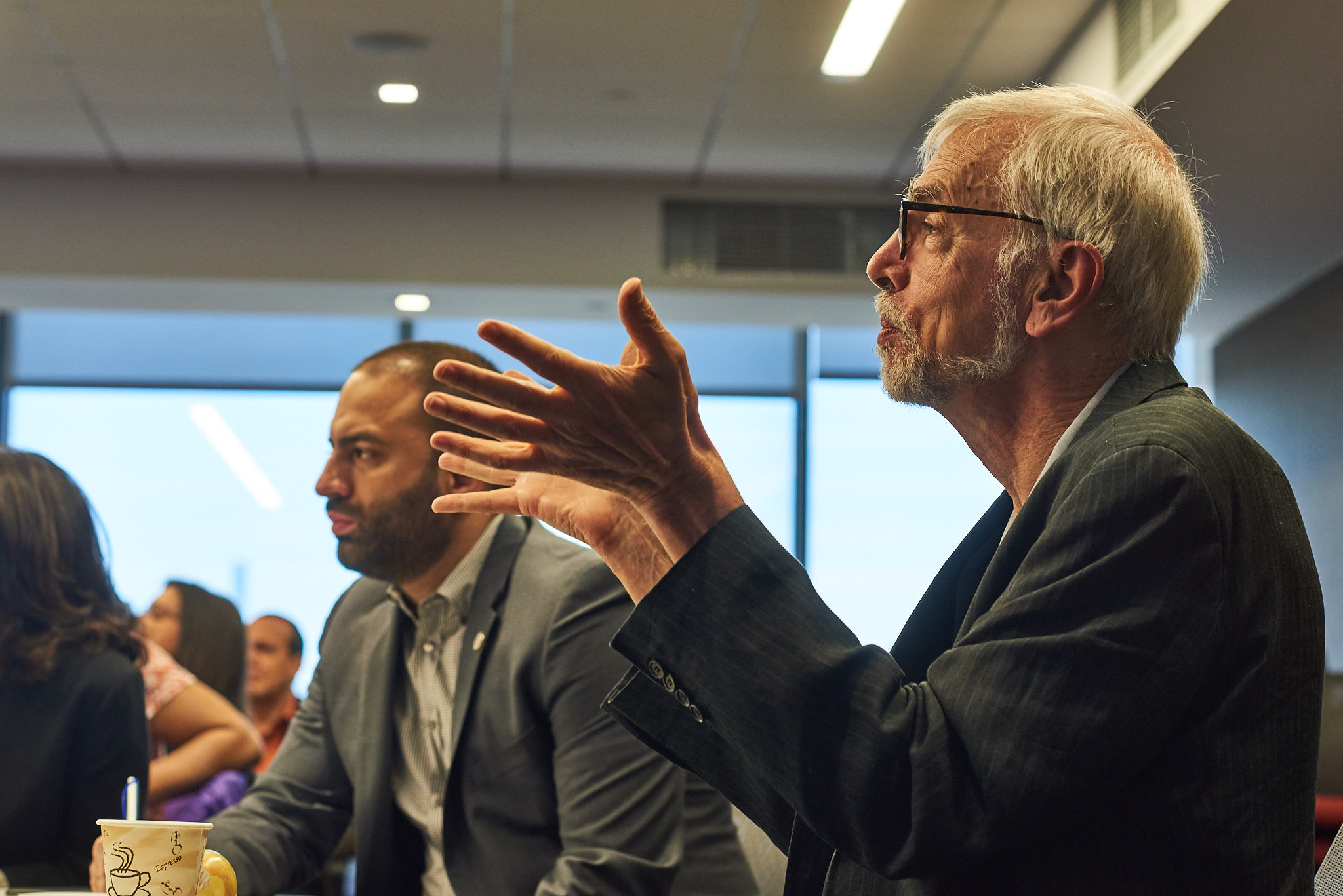 Nicholas Freudenberg, Director, CUNY Urban Food Policy Institute, in discussion with store operators and representatives from city government, philanthropy and nonprofit organizations addressing the food needs of New Yorkers. photo credit: Reeve Jolliffe