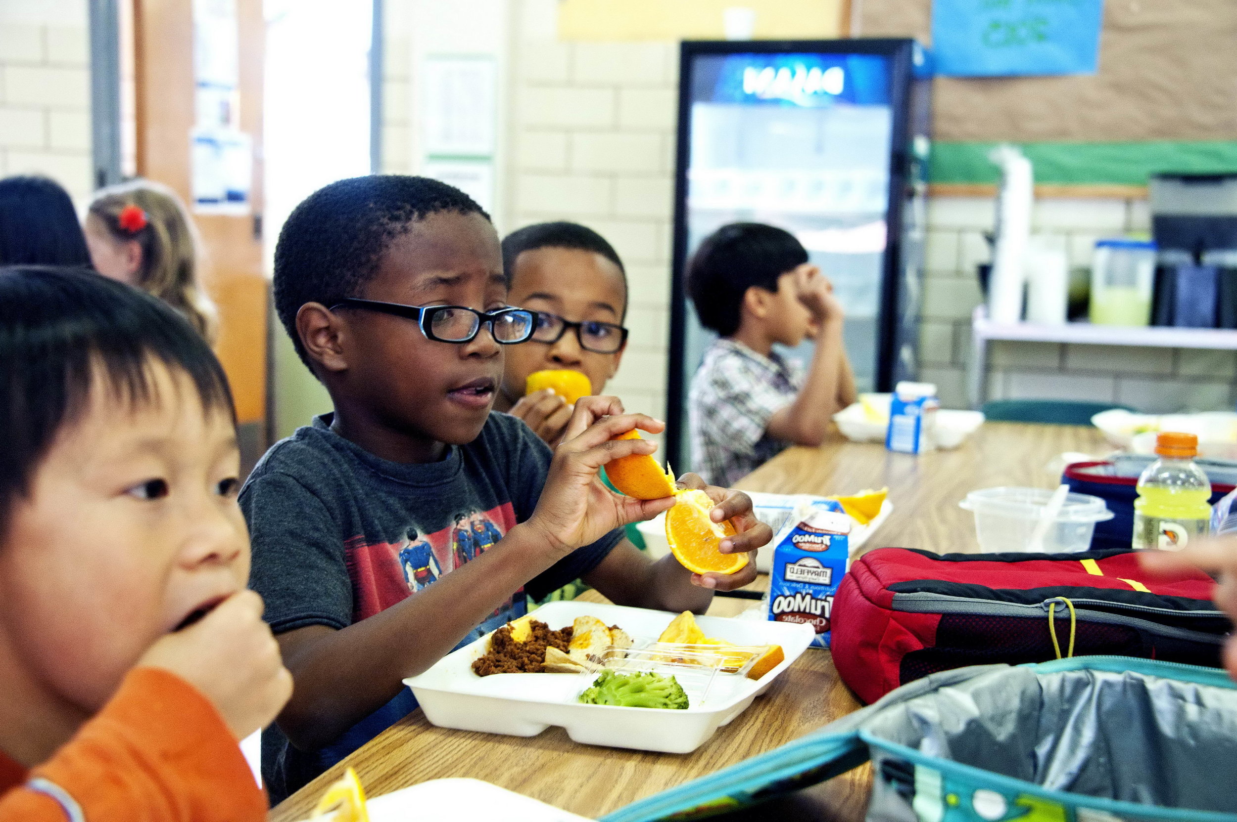 Child eating school lunch. Public domain