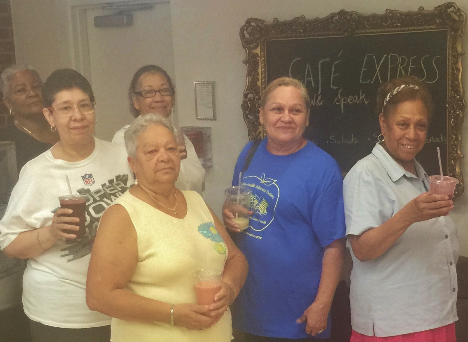 NYCHA residents enjoying smoothies from Cafe Express, a community-driven food project run by SCAN-NY as part of the Building Healthy NYCHA Communities Through Food Initiative. Photo courtesy of SCAN-NY.
