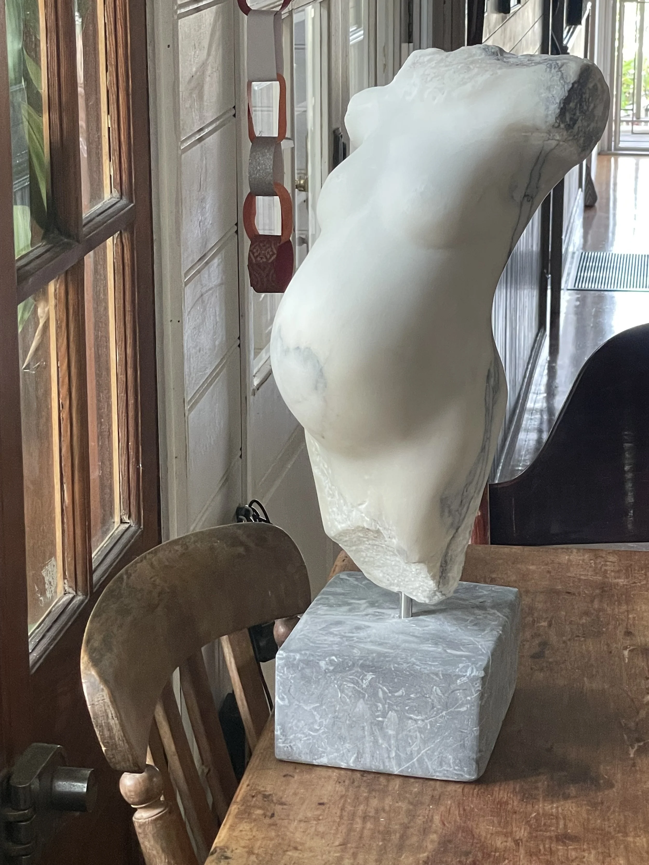  It was mystical - As I was carving the torso the veins of the marble revealed a heart where the baby was sitting in the torso  