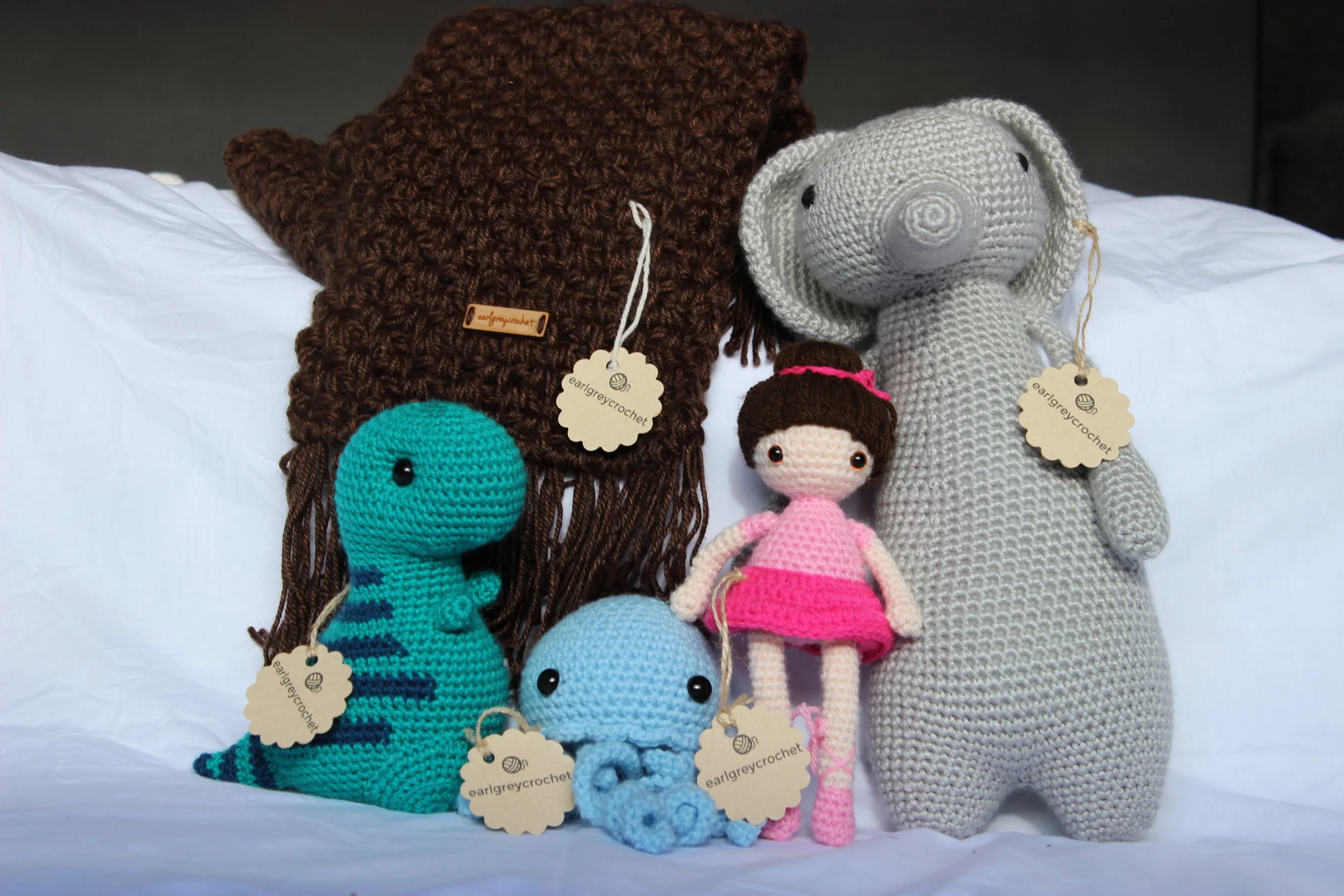 Moss Fringe Scarf, available in my shop, based on pattern by Stephanie of AllAboutAmi. Dinosaur pattern by Bluephone Studios on Etsy. Jellyfish pattern by Ana Paula Rimoli. Doll designed by me! Elephant by LittleBearCrochets on Instagram and Etsy.