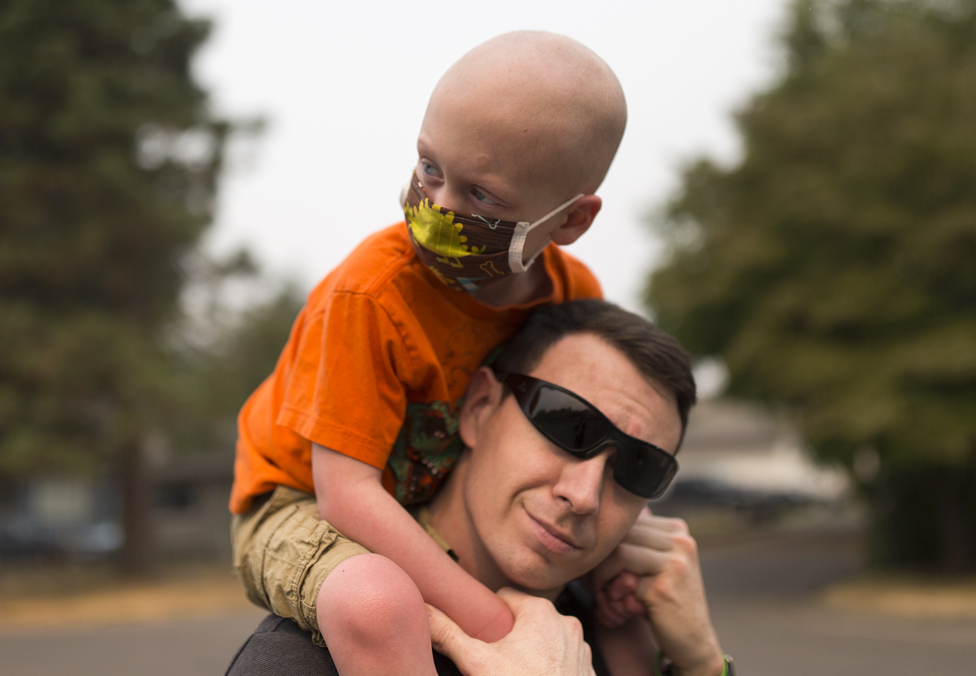  Declan Reagan, 5, sits atop of Francis' shoulders outside the Washougal Police Department where his dad works in Washougal on Tuesday, Sept. 5, 2017. Declan's leukemia relapsed earlier this year and he was also diagnosed with lymphoma. A recent bone